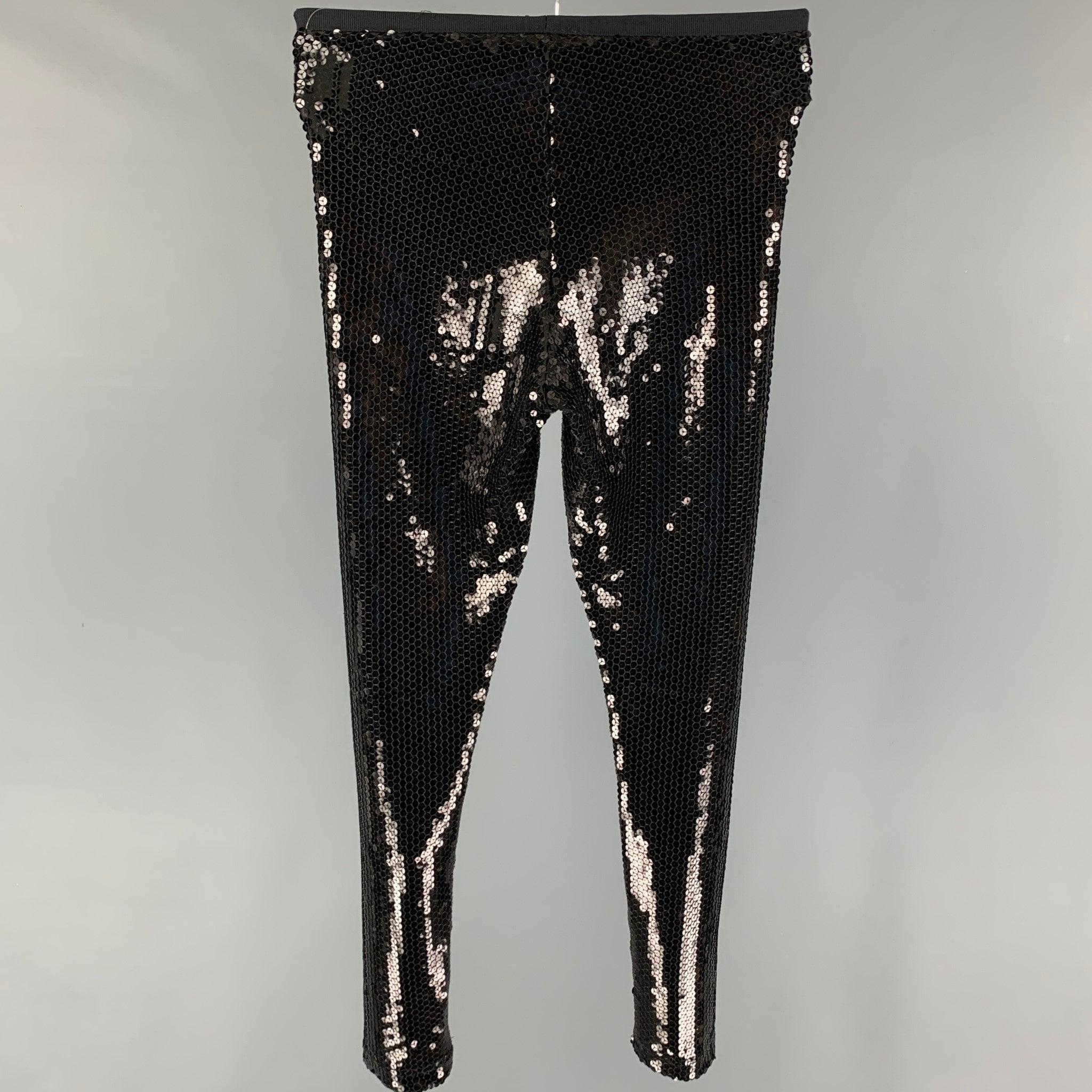MARC JACOBS leggings comes in a black sequined polyester featuring a elastic ribbon waist.
 Good
 Pre-Owned Condition. Moderate wear. As-is.  
 

 Marked:  0 
 

 Measurements: 
  Waist: 25 inches Rise: 10 inches Inseam: 28 inches Leg Opening: 10