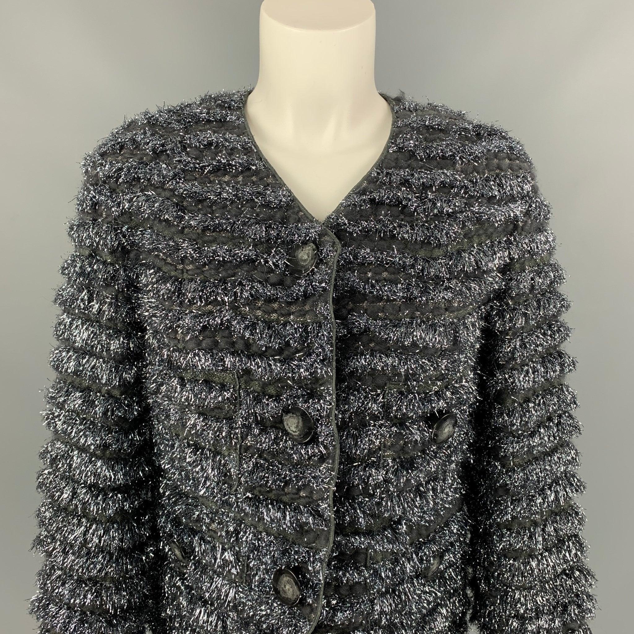 MARC JACOBS jacket comes in a silver & grey metallic wool blend with a full liner featuring a collarless style, cropped, fringe trim, button details, and a snap button closure. Made in USA.
New With Tags.
 

Marked:   0 

Measurements: 
 
Shoulder: