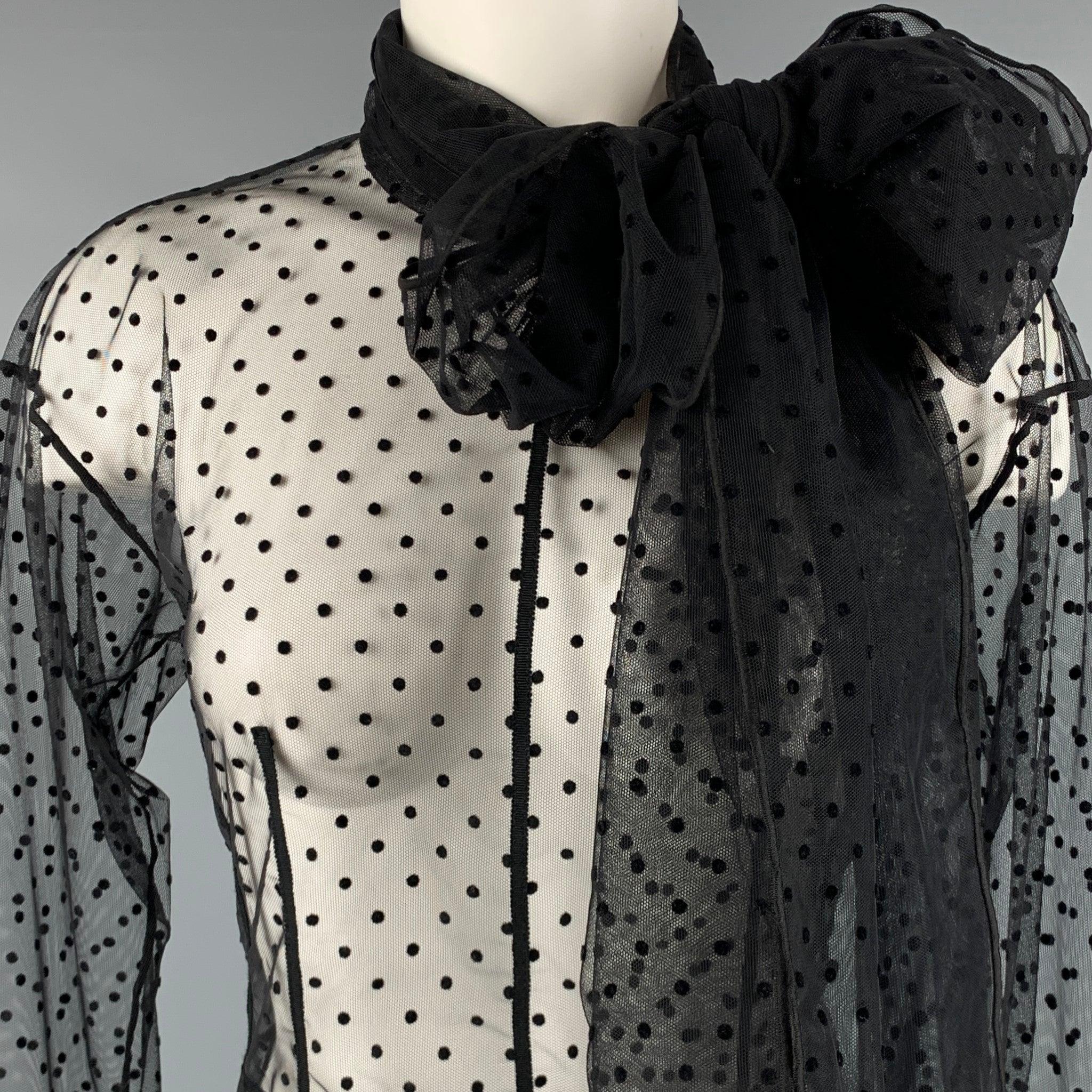 MARC JACOBS blouse
in a
black fabric featuring a sheer style, black dots pattern, large pussy bow, and back zipper closure. Excellent Pre-Owned Condition. Care and fabric tags have been removed. 

Marked:   2 

Measurements: 
 
Shoulder: 18.5 inches