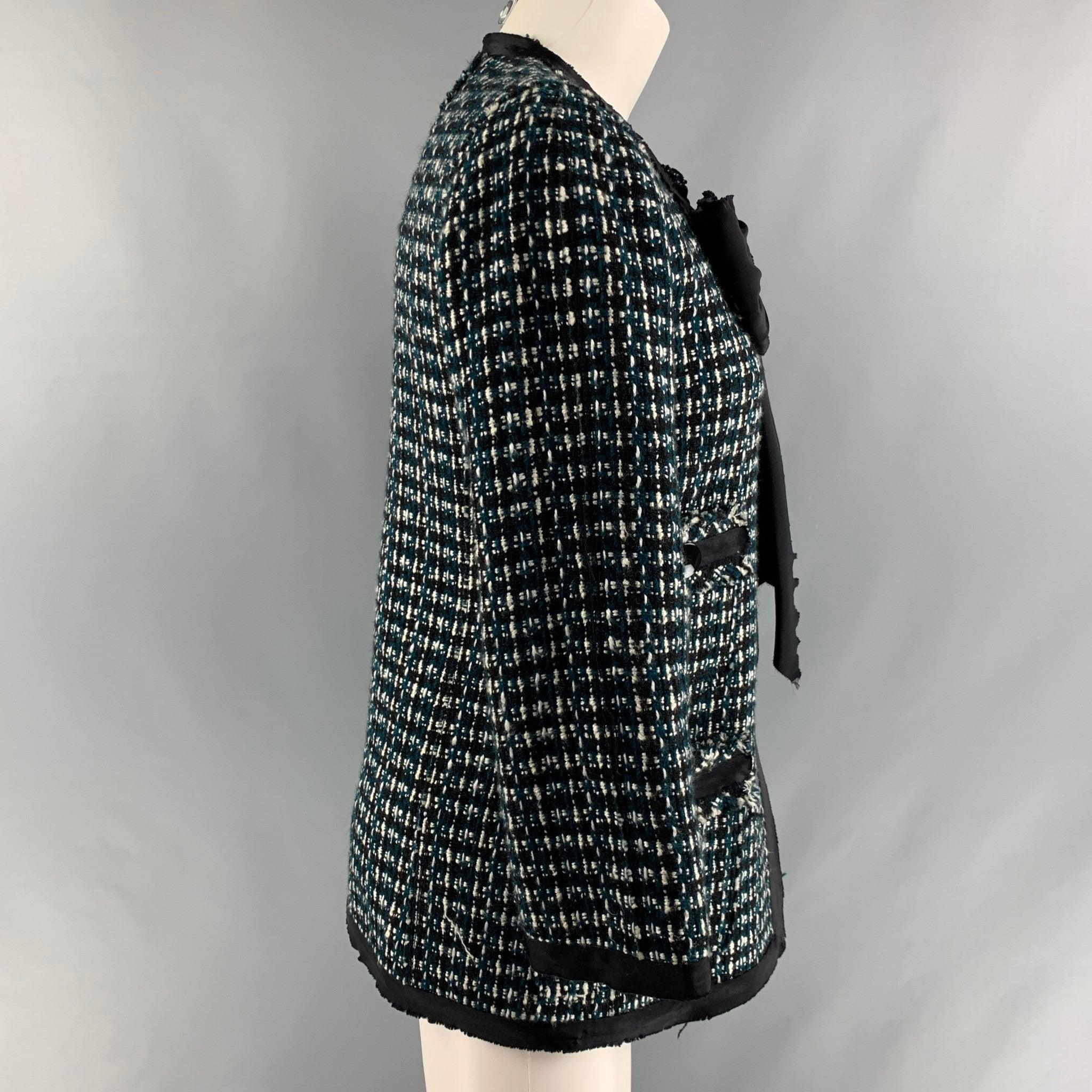 MARC JACOBS jacket comes in black, white and green wool modal boucle with a silk bow at collar, four pocket at front and hook and eye closure. Made in USA.Very Good Pre-Owned Condition. Moderate signs of wear. 
 

 Marked:  2 
 

 Measurements: 
  
