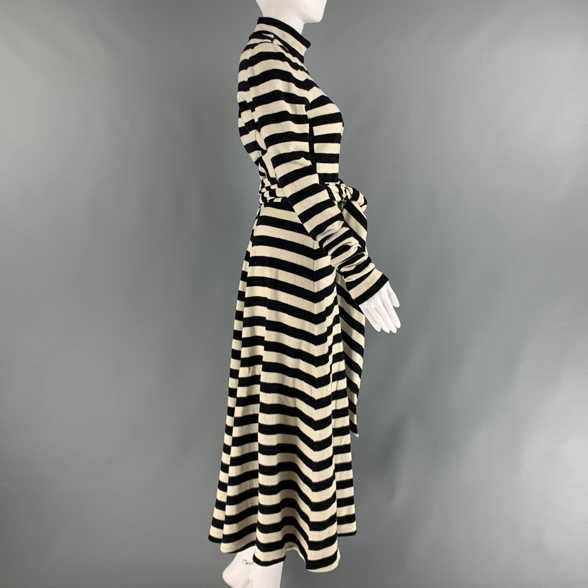MARC JACOBS RUNWAY long sleeve maxi dress comes in black and white wool and nylon stripped jersey knit material featuring A-line silhouette, high neck, waist tie and half zip up closure at center back. Made in USA.Very Good Pre- Owned Condition.