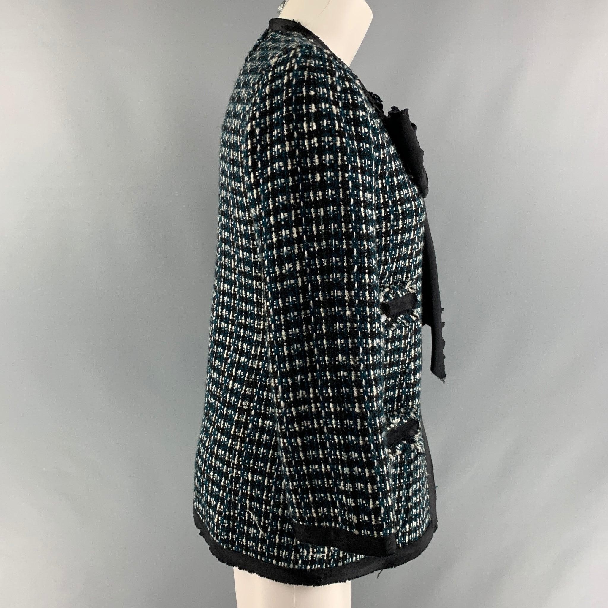 MARC JACOBS jacket in a black, white and green wool modal boucle with a silk bow at collar, four pocket at front and hook and eye closure. Made in USA.Very Good Pre-Owned Condition. Moderate signs of wear. 

Marked:   2 

Measurements: 
 
Shoulder: