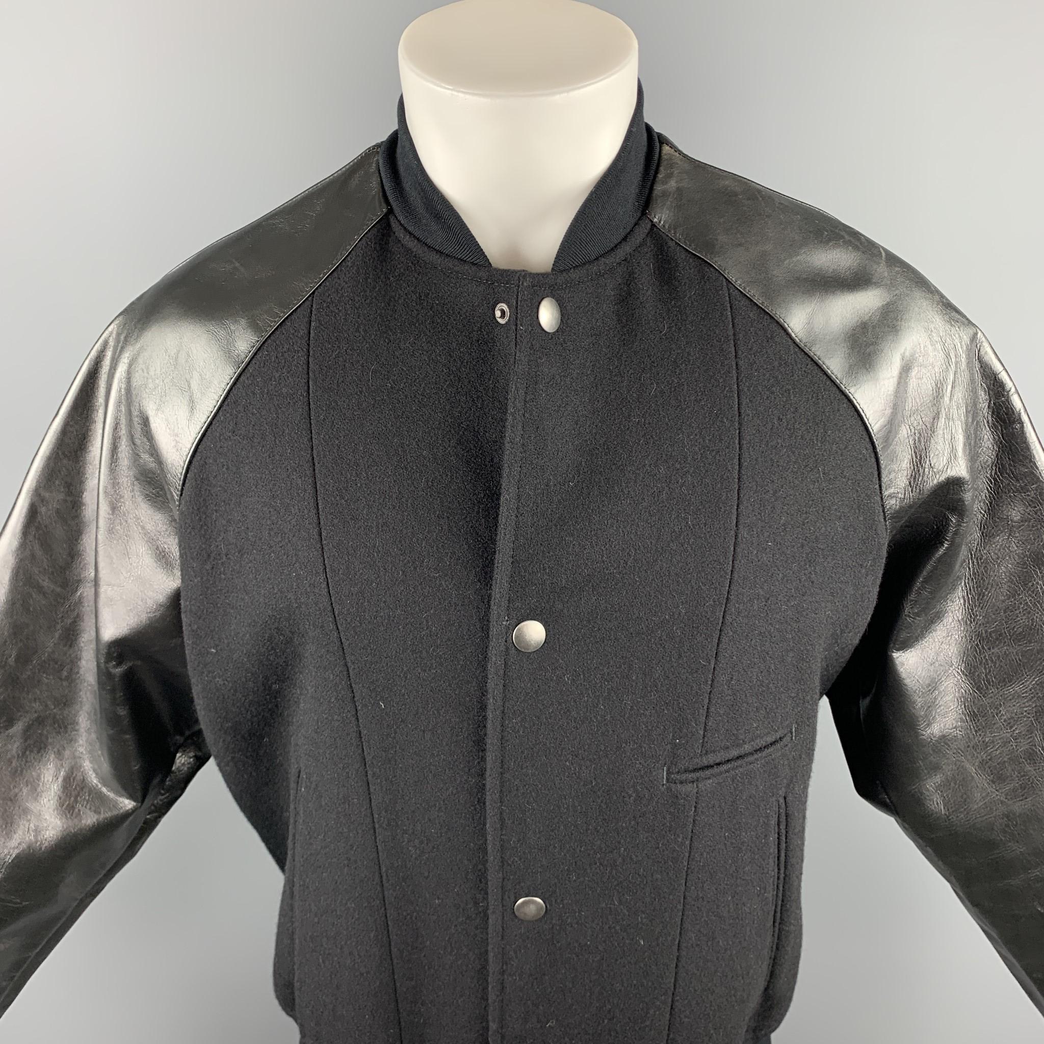 MARC JACOBS jacket comes in a black wool with mixed materials featuring leather sleeves, slit pockets, and a snap button closure. Made in Italy.

Excellent Pre-Owned Condition.
Marked: IT 48

Measurements:

Shoulder: 17 in. 
Chest: 38 in. 
Sleeve: