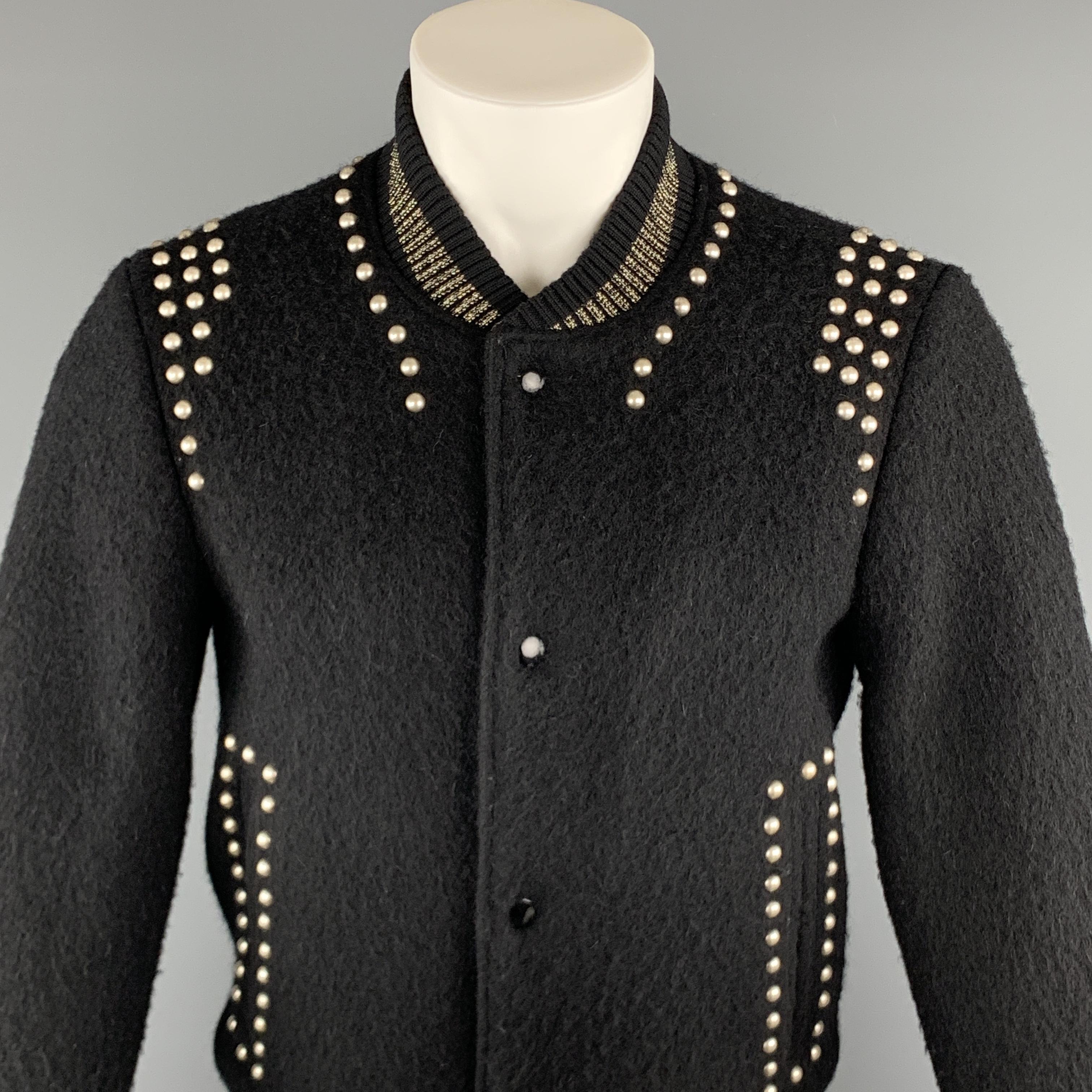 MARC JACOBS Jacket comes in a black wool featuring a bomber style, studded details, and a gold tone metallic trim. Made in Italy.

Very Good Pre-Owned Condition.
Marked: 48

Measurements:

Shoulder: 18 in. 
Chest: 38 in. 
Sleeve: 25 in. 
Length: 26