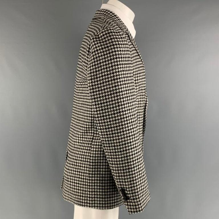 MARC JACOBS sport coat comes in a black white houndstooth wool woven material featuring a notch lapel, flap pockets, single back vent, and a double button closure. Made in Italy.New with Tags. 

Marked:   48 

Measurements: 
 
Shoulder: 17.5 inches