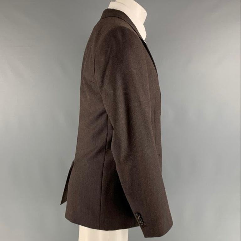 MARC JACOBS sport coat comes in a brown wool woven material featuring a notch lapel, flap pockets, single back vent, and a double button closure. Made in Italy.Very Good Pre Owned Condition. Minor Mark at left panel. 

Marked:   48 

Measurements: 
