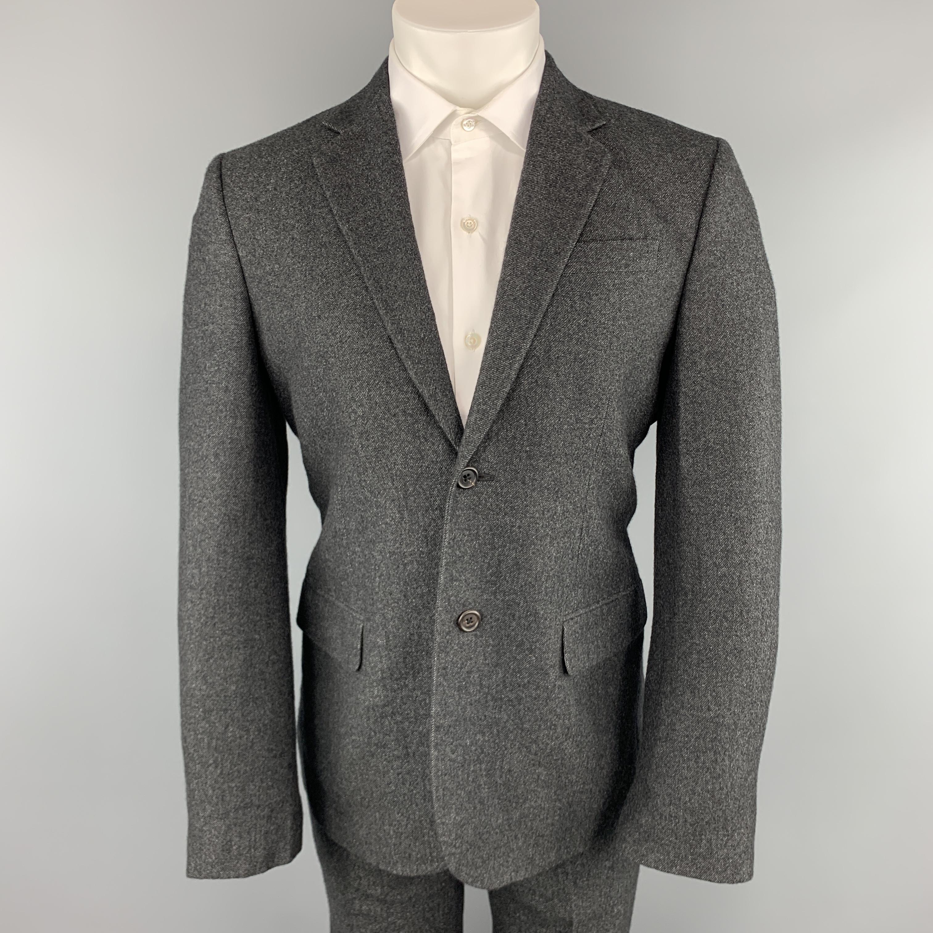 MARC JACOBS suit comes in charcoal textured cashmere and includes a  single breasted, two button sport coat with notch lapel and matching flat front wide leg trousers. Made in Italy.

Excellent Pre-Owned Condition.
Marked: IT
