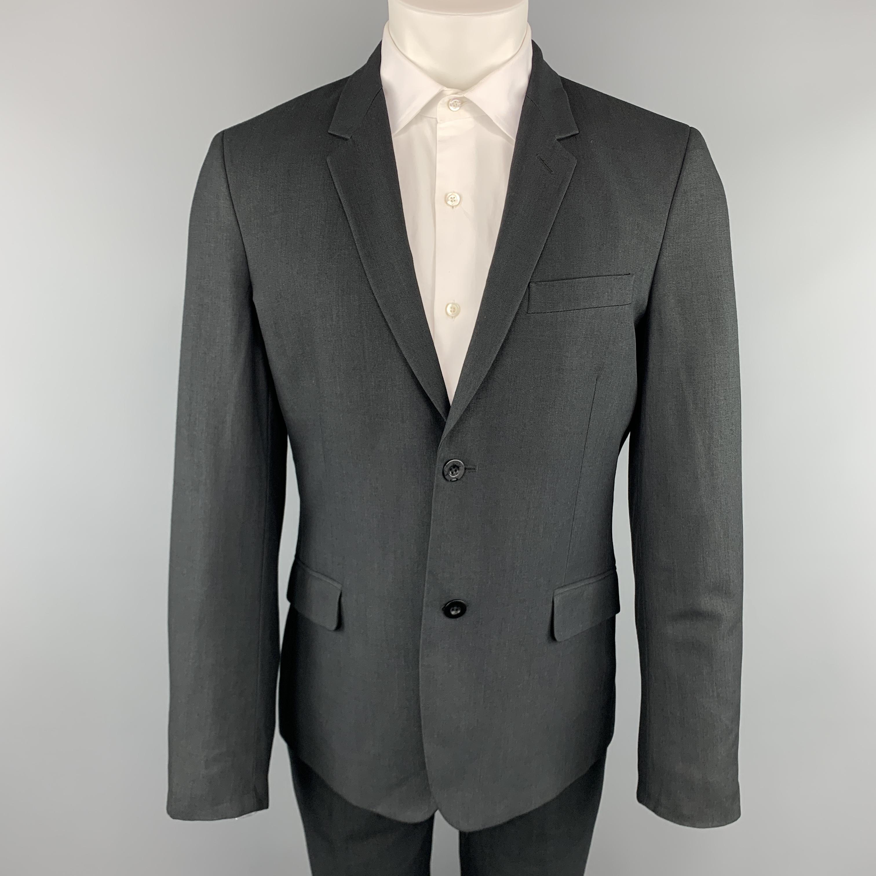 MARC JACOBS suit comes in charcoal woven wool blend fabric and includes a single breasted, two button sport coat with a notch lapel and matching flat front trousers. Made in Italy.

Excellent Pre-Owned Condition.
Marked: IT