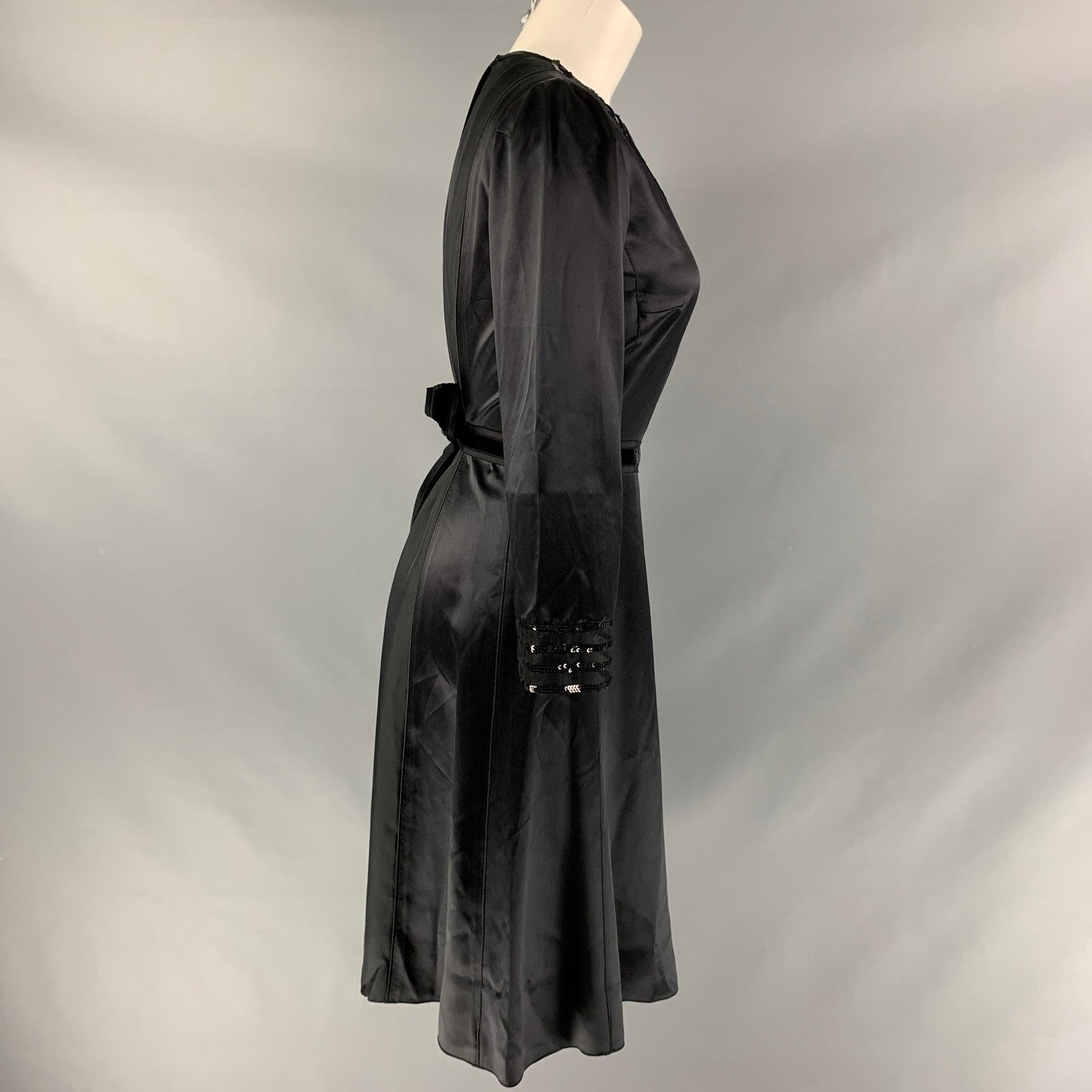 MARC JACOBS long sleeve dress comes in a black silk fabric featuring a tulle panel collar detail, sequin trims, back zip- up closure and velvet tie at back.Excellent Pre-Owned Condition. 
 

 Marked:  4 
 

 Measurements: 
  
 Shoulder: 14 inches