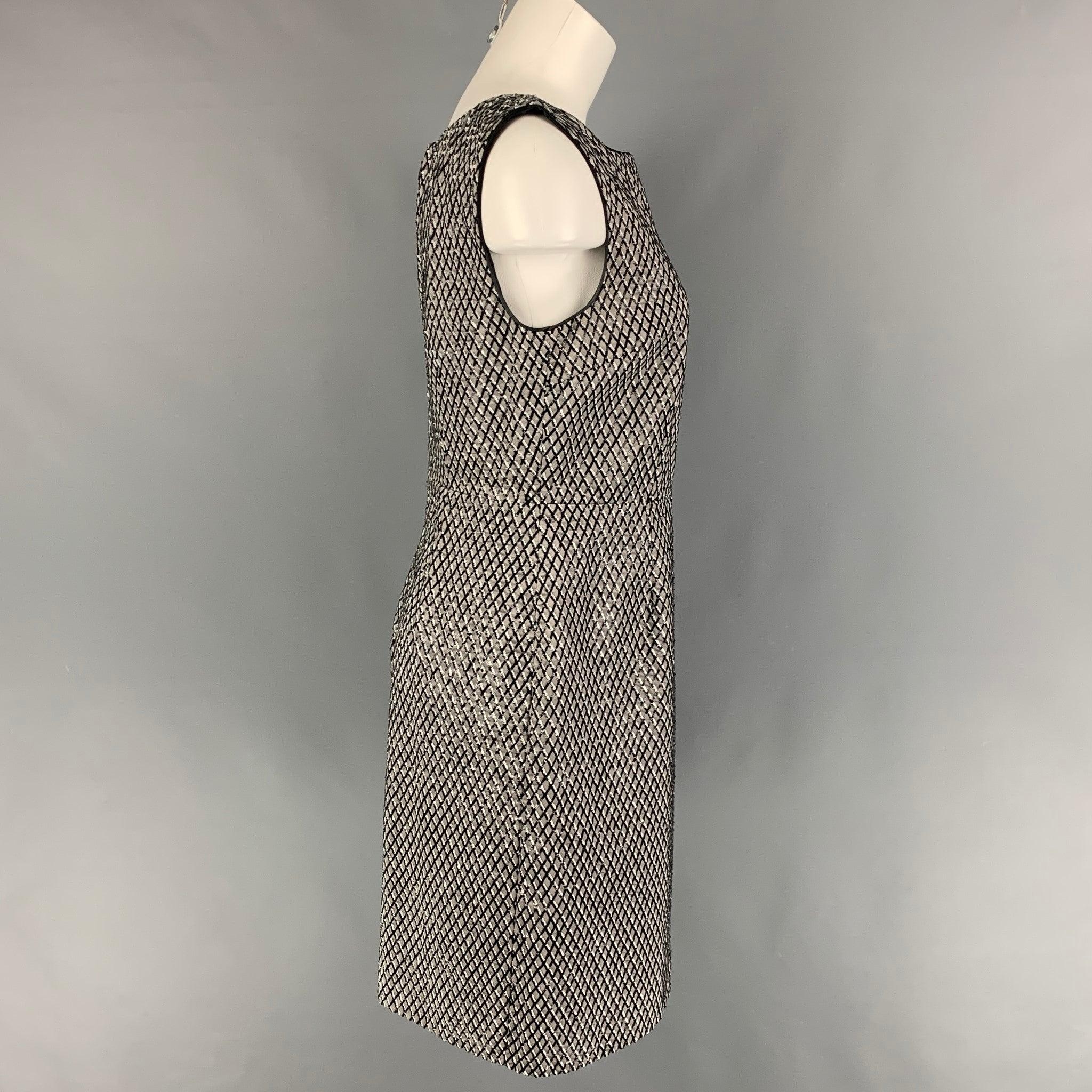 MARC JACOBS dress comes in a gray & black sequined silk featuring a shift style, sleeveless, and a back zip up closure. Made in USA.
Excellent
Pre-Owned Condition. 

Marked:   4 

Measurements: 
 
Shoulder: 15.5 inches  Bust: 34 inches  Waist: 30