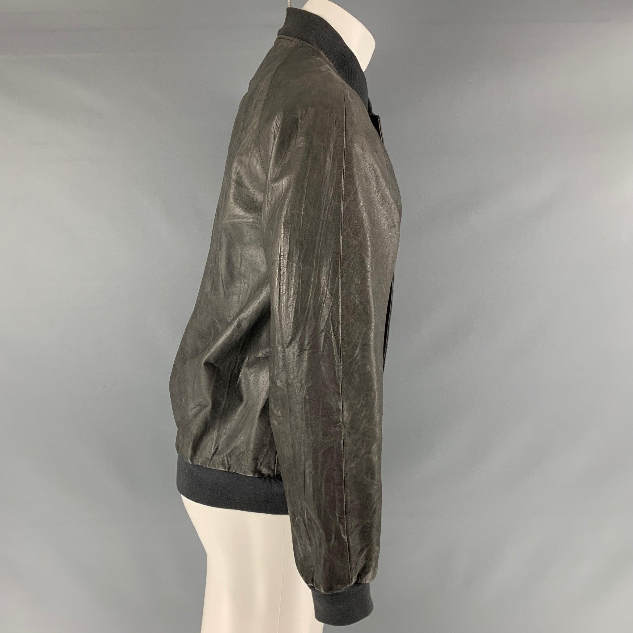 MARC JACOBS jacket comes in a grey leather material featuring a bomber style, skinny fit, ribbed hem, slit pockets, and a zip up closure. Made in Italy. Good Pre- Owned Conditions. Moderate signs of wear and marks. 

Marked:   50 

Measurements: 
