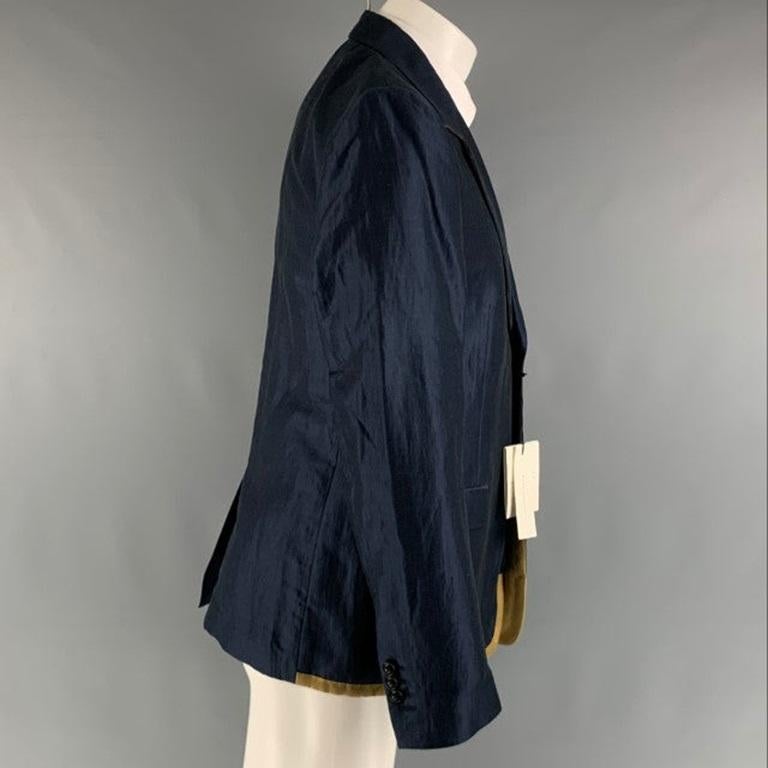 MARC JACOBS sport coat comes in a navy ramie and cotton woven material featuring a notch lapel, gold detail at hem, flap pockets, single back vent, and a double button closure. Made in Italy.New with Tags. 

Marked:   50 

Measurements: 
 
Shoulder: