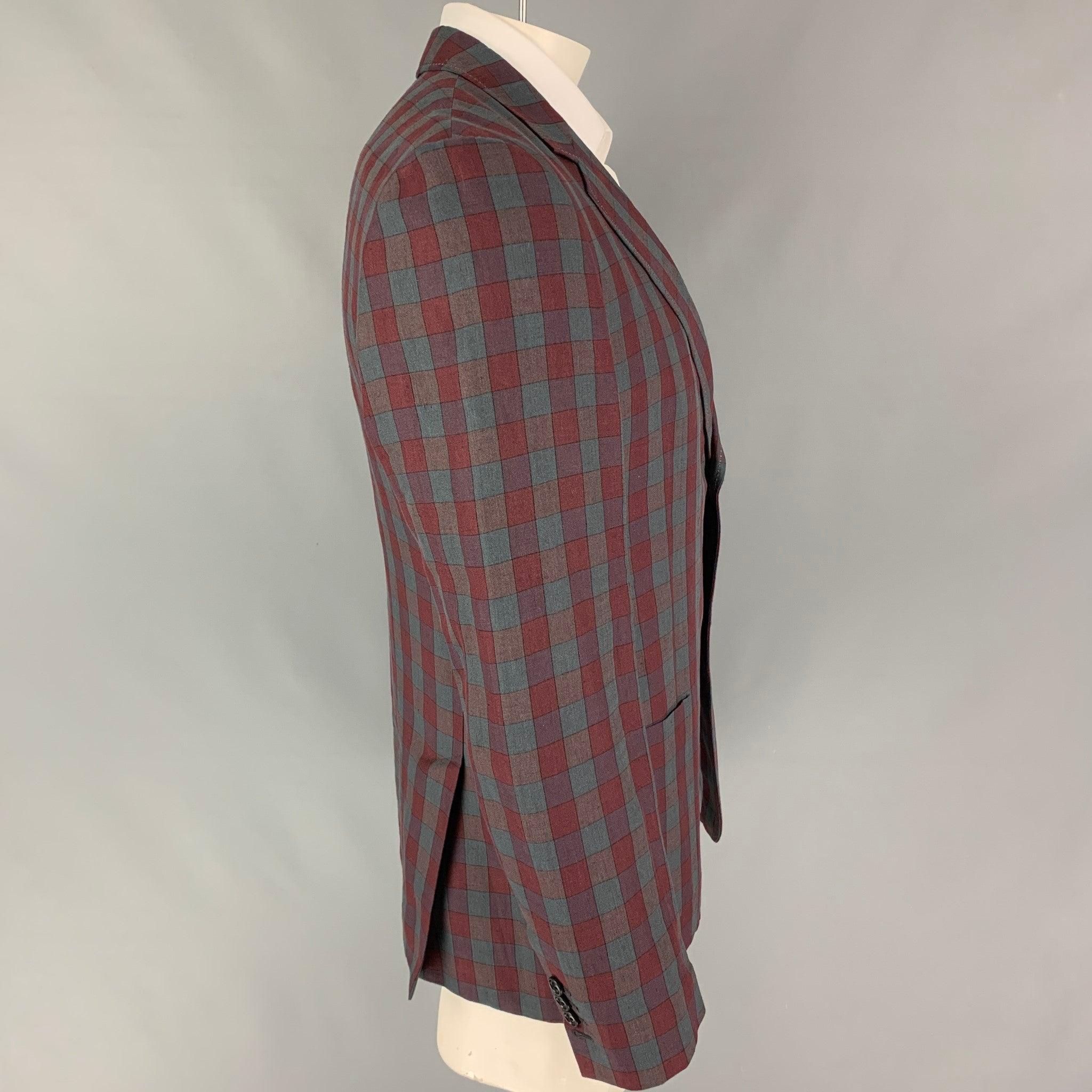 MARC JACOBS sport coat comes in a burgundy & grey plaid linen with a half liner featuring a notch lapel, patch pockets, double back vent, and a double button closure. Made in Italy.
Very Good
Pre-Owned Condition. 

Marked:   52 

Measurements: 
