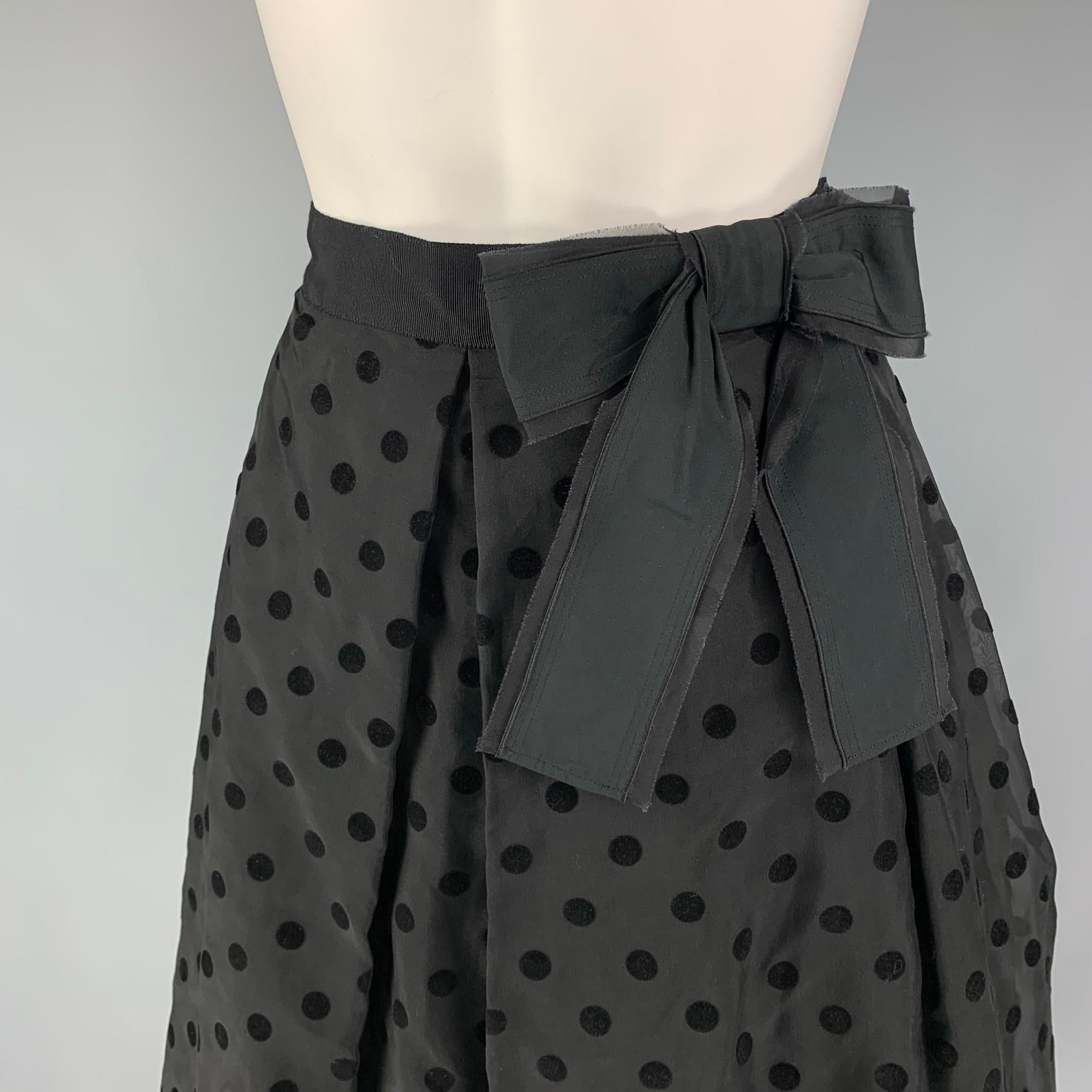 MARC JACOBS skirt comes in a black polyester with a slip liner featuring a overlay design, polka dot details, front bow design, and a sie zipper closure. 

New with tags. 
Marked: 8

Measurements:

Waist: 30 in.
Hip: 42 in.
Length: 25 in.