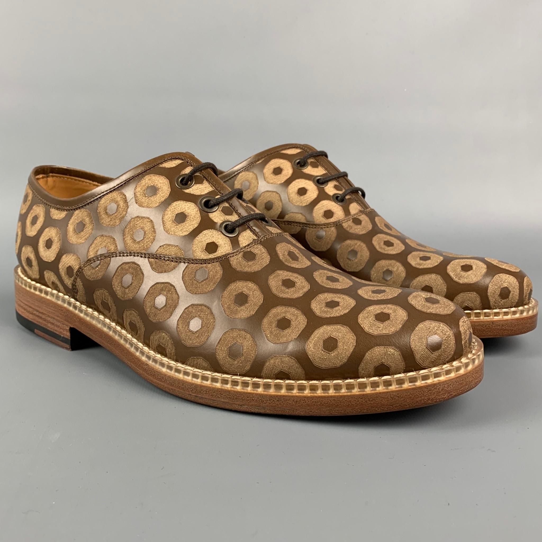 MARC JACOBS shoes comes in a brown leather featuring a laser cut design featuring a round toe and a lace up closure. Made in Italy.

Excellent Pre-Owned Condition.
Marked: 41 / 7

Outsole: 11 in. x 4 in. 