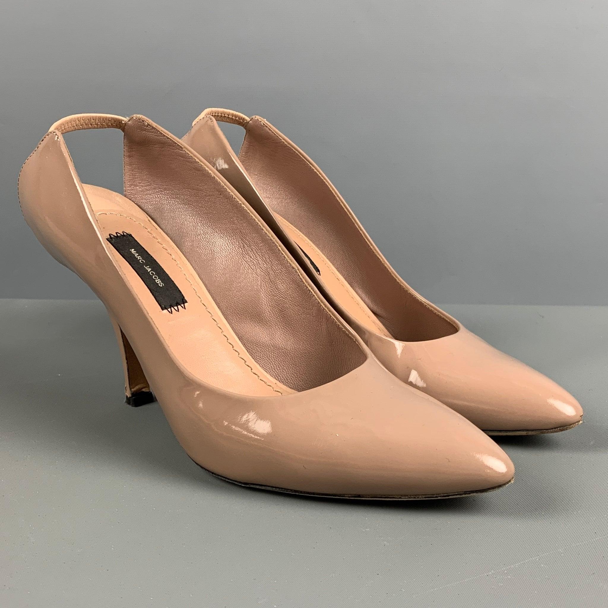 MARC JACOBS pumps comes in a taupe patent leather featuring a slingback closure, pointed toe, and a kitten heels. Comes with Box. Made in Italy. Very Good Pre-Owned Condition. Moderate signs of wear. 

Marked:   38 

Measurements: 
  Heel: 3.5