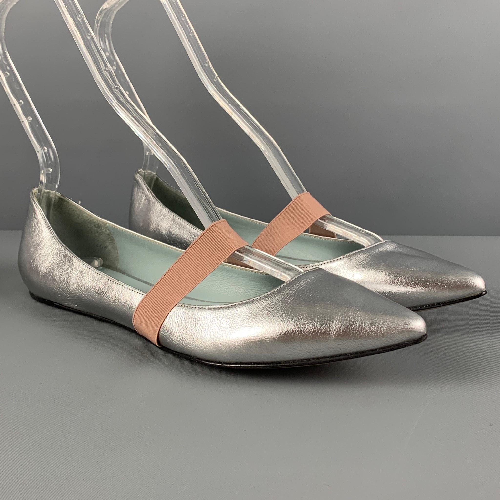 MARC JACOBS flats comes in a silver leather featuring a mary jane style, elastic strap, and a pointed toe. 

Very Good Pre-Owned Condition.
Marked: 38.5
Original Retail Price: $295.00

Outsole: 10.5 in. x 3.25 in.

 