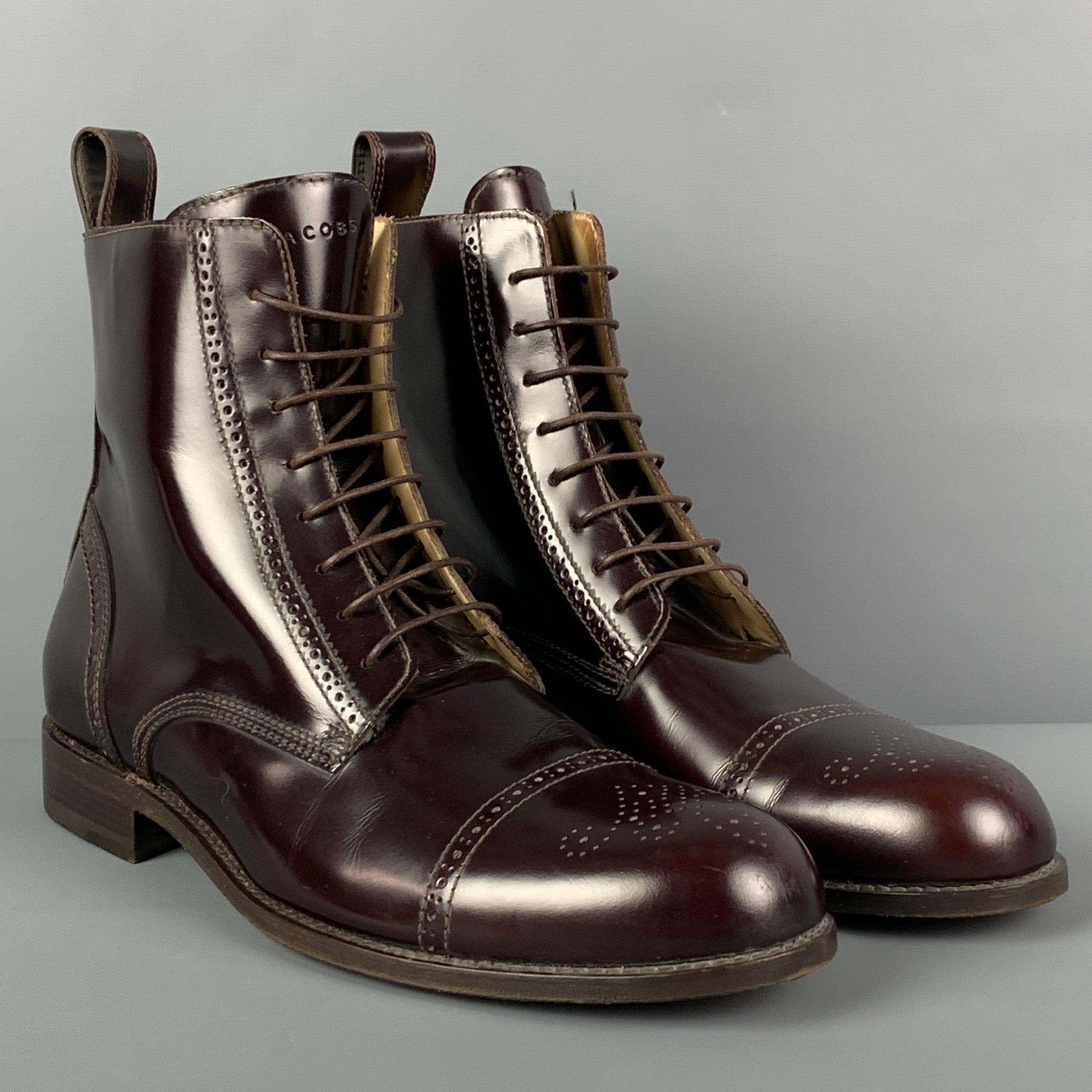 MARC JACOBS ankle boots comes in a burgundy perforated leather featuring a cap toe ad a lace up closure. Handmade in Italy.
Very Good
Pre-Owned Condition. 

Marked:   8.5 

Measurements: 
  Length: 12 inches  Width: 4 inches  Height: 6 inches 
  
 