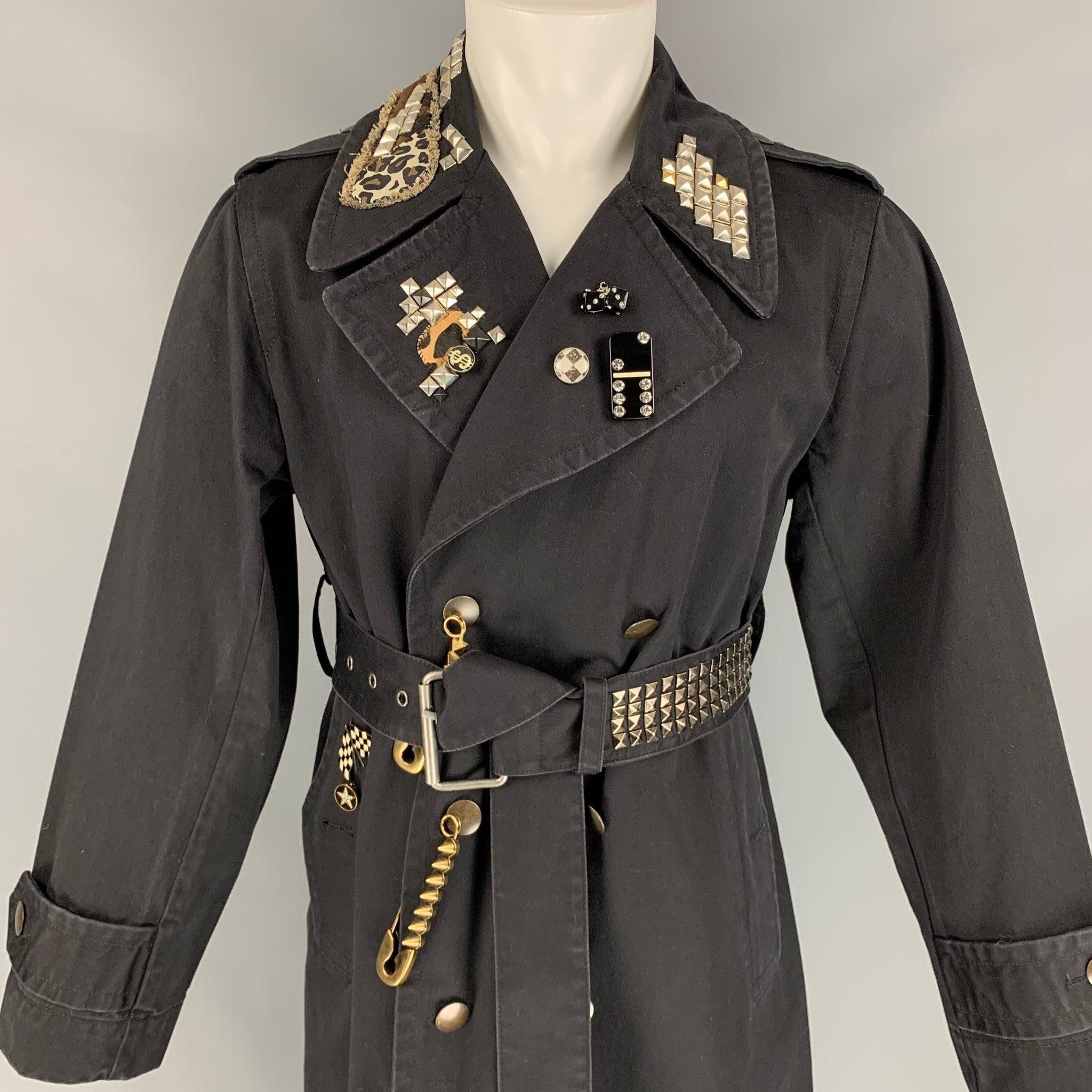 MARC JACOBS trenchcoat comes in a black cotton featuring a belted style, studded details, metal pins, embroidered patch, single back vent, slit pockets, and a double breasted closure.
New With Tags.
 

Marked:  M/M 

Measurements: 
 
Shoulder:
17