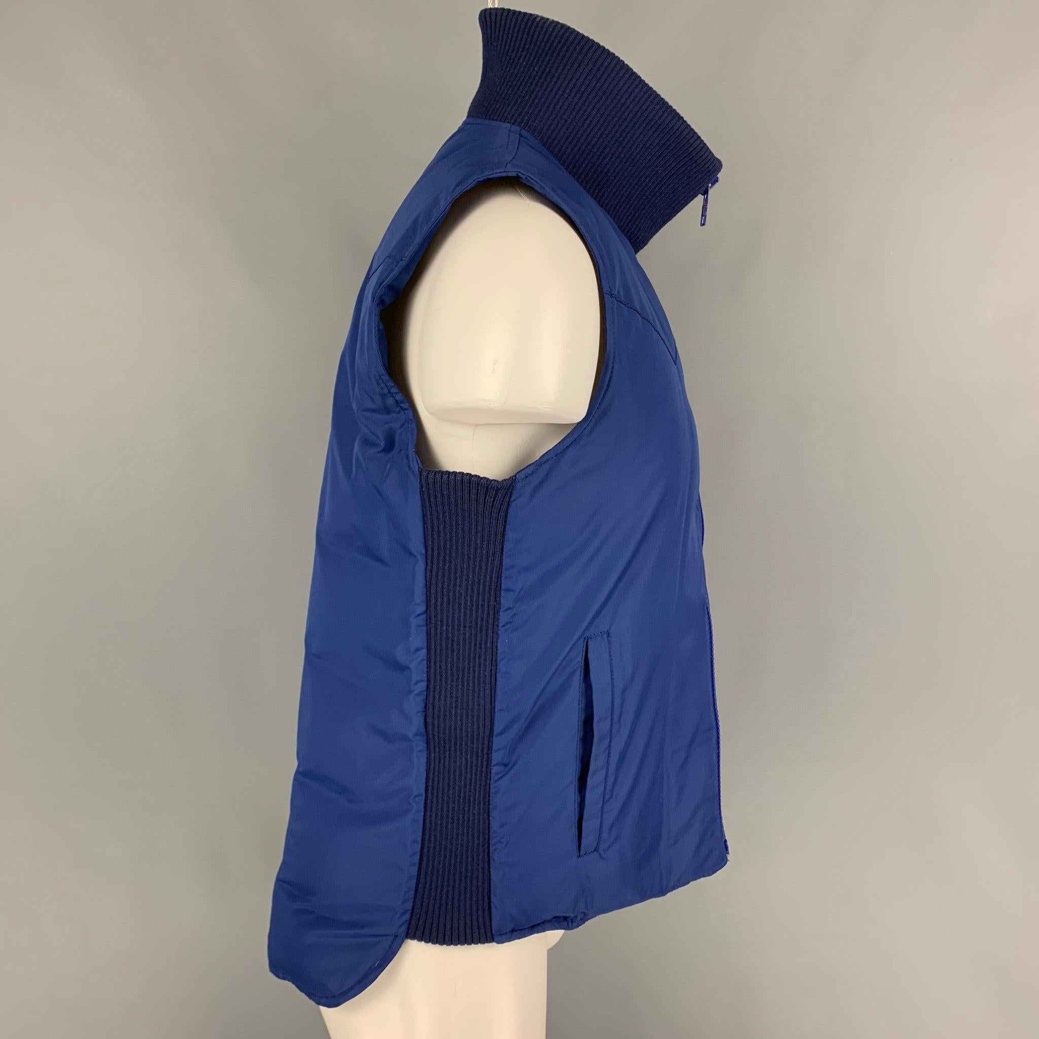 MARC JACOBS vest comes in a blue quilted polyester featuring a high collar, ribbed hem, slit pockets, and a zip up closure.
 Very Good
 Pre-Owned Condition. 
 

 Marked:  48 
 

 Measurements: 
  
 Shoulder:
 16 inches Chest: 42 inches Length: 27