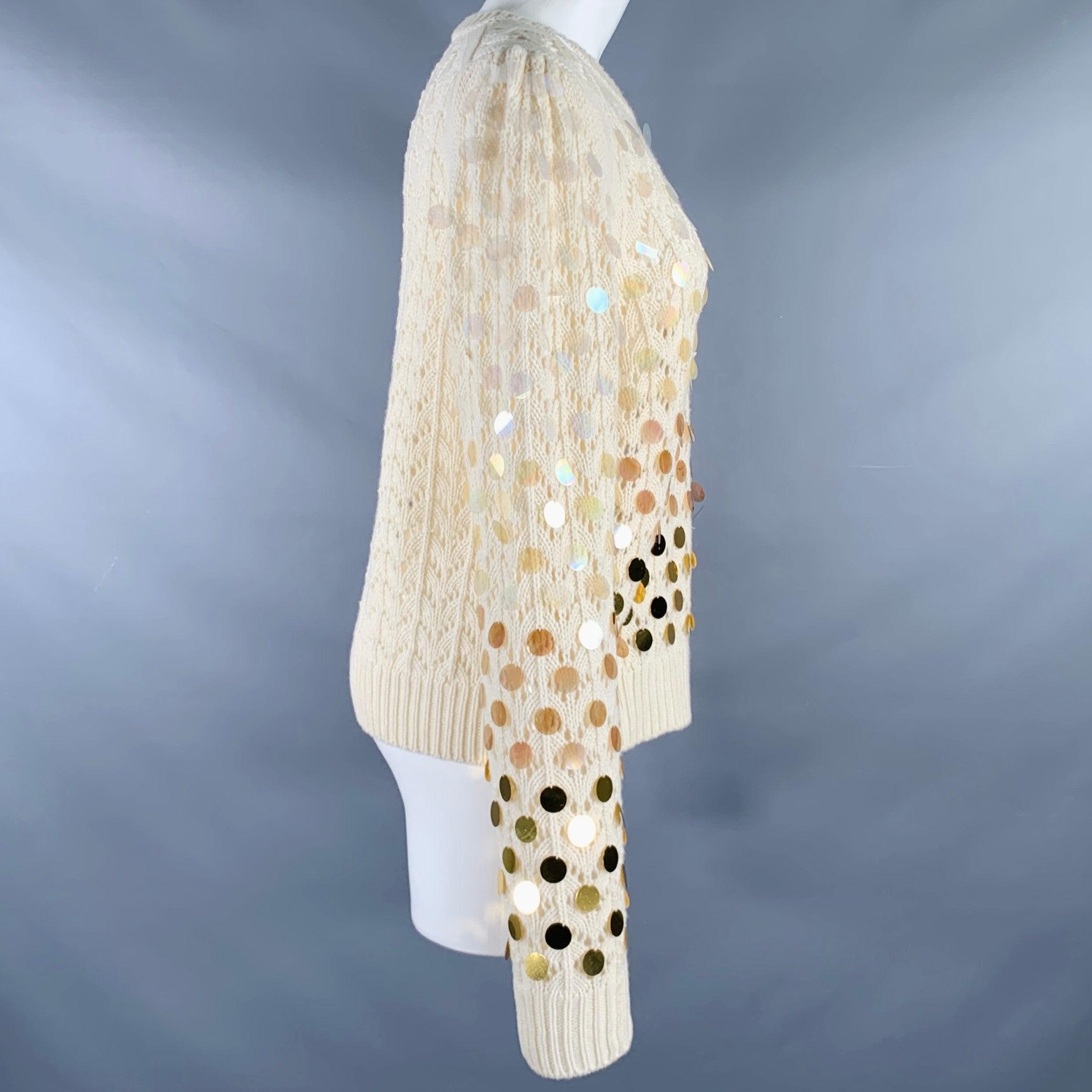 MARC JACOBS sweater in a cream wool cashmere blend knit featuring payette sequins which ombre from clear to an opaque gold, lace-like see-through knit technique, raised shoulders, and a crew neck.Very Good Pre-Owned Condition. Moderate signs of wear