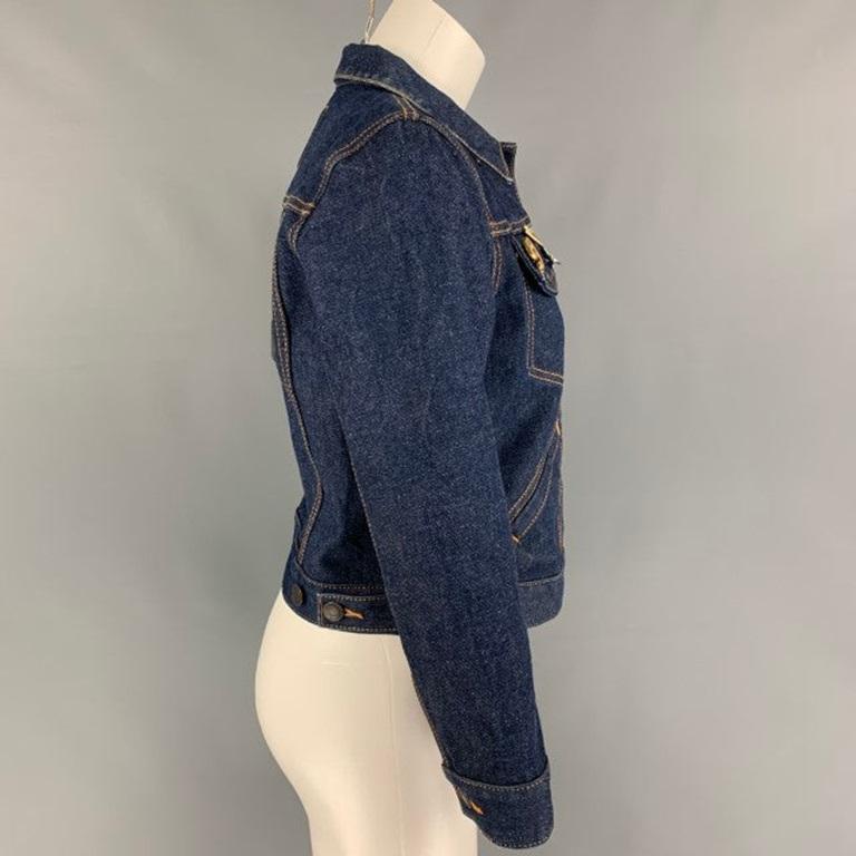 MARC JACOBS jacket comes in a dark indigo denim featuring a cropped style, contrast stitching, front pockets, metal pin details, back 'MJ' patch design, spread collar, and a buttoned closure.
Excellent
Pre-Owned Condition. 

Marked:   M 