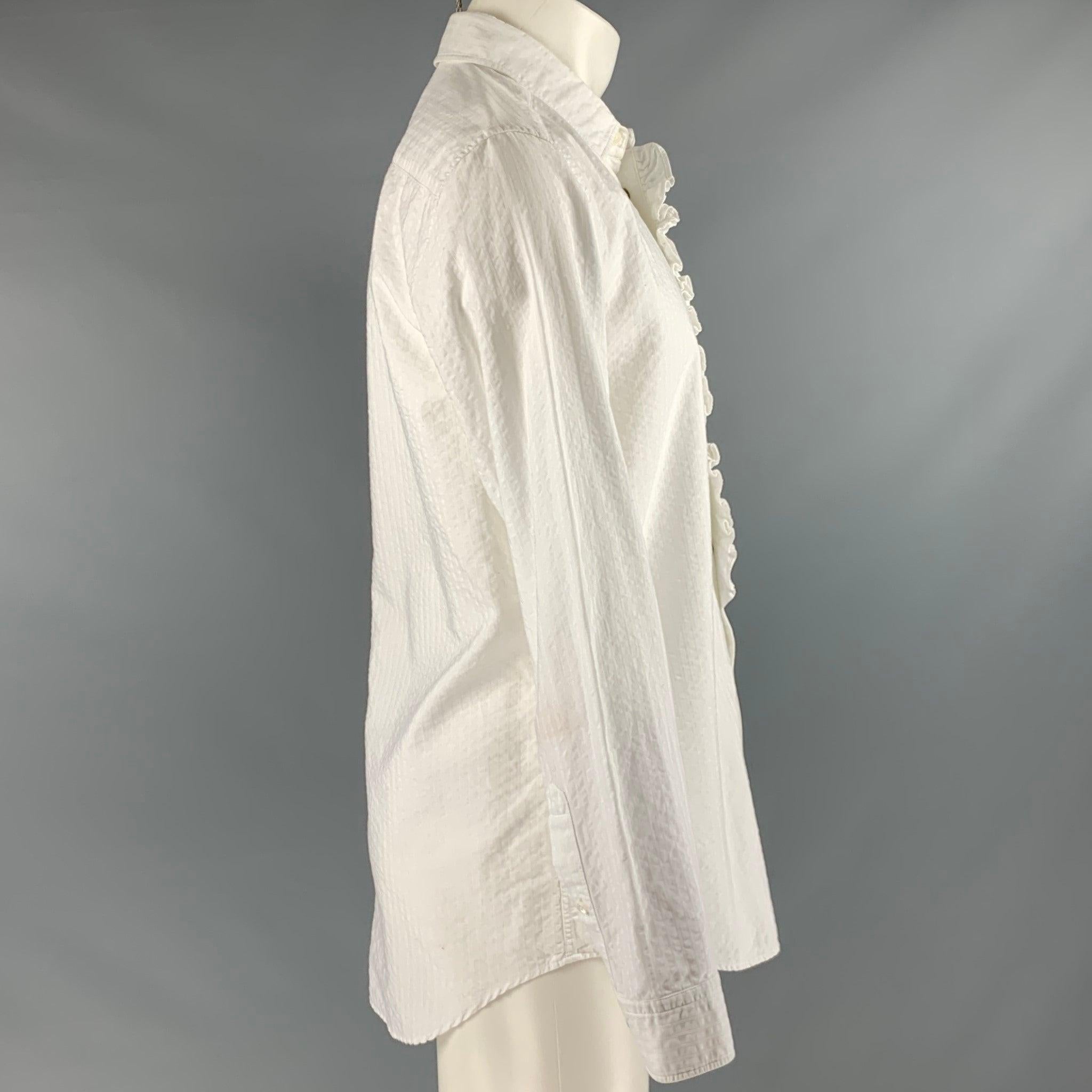 MARC JACOBS long sleeve shirt
in a white cotton fabric featuring seersucker pattern, ruffle front, and snaps closure. Made in Italy.Very Good Pre-Owned Condition. Minor signs of wear. 

Marked:   50 

Measurements: 
 
Shoulder: 17 inches Chest: 40