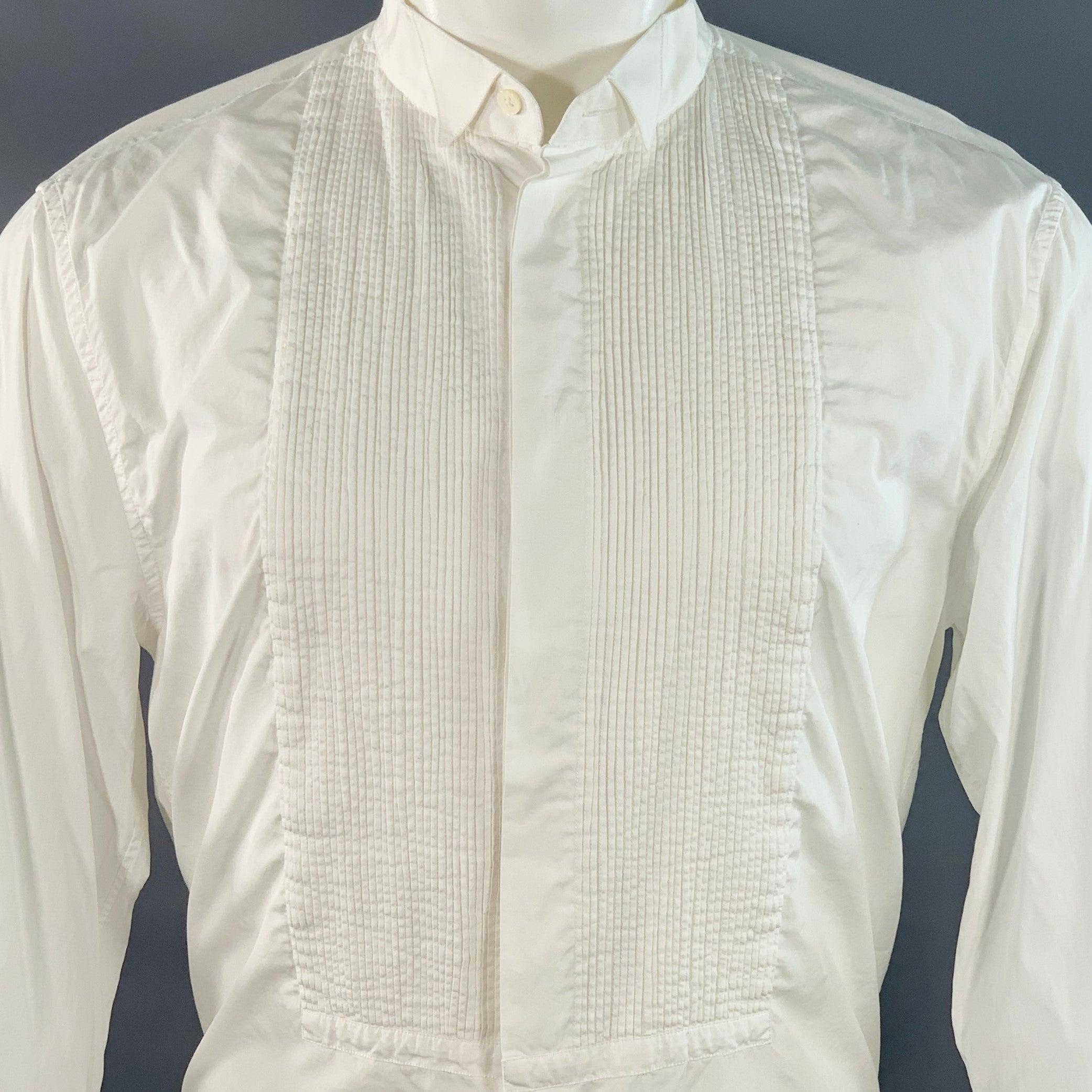 MARC JACOBS tuxedo long sleeve shirt
in a white cotton woven fabric featuring a pleated bib front, formal wingtip collar, French cuffs, and button closure. Made in Italy.Very Good Pre-Owned Condition. Minor signs of wear. 

Marked:   IT 48