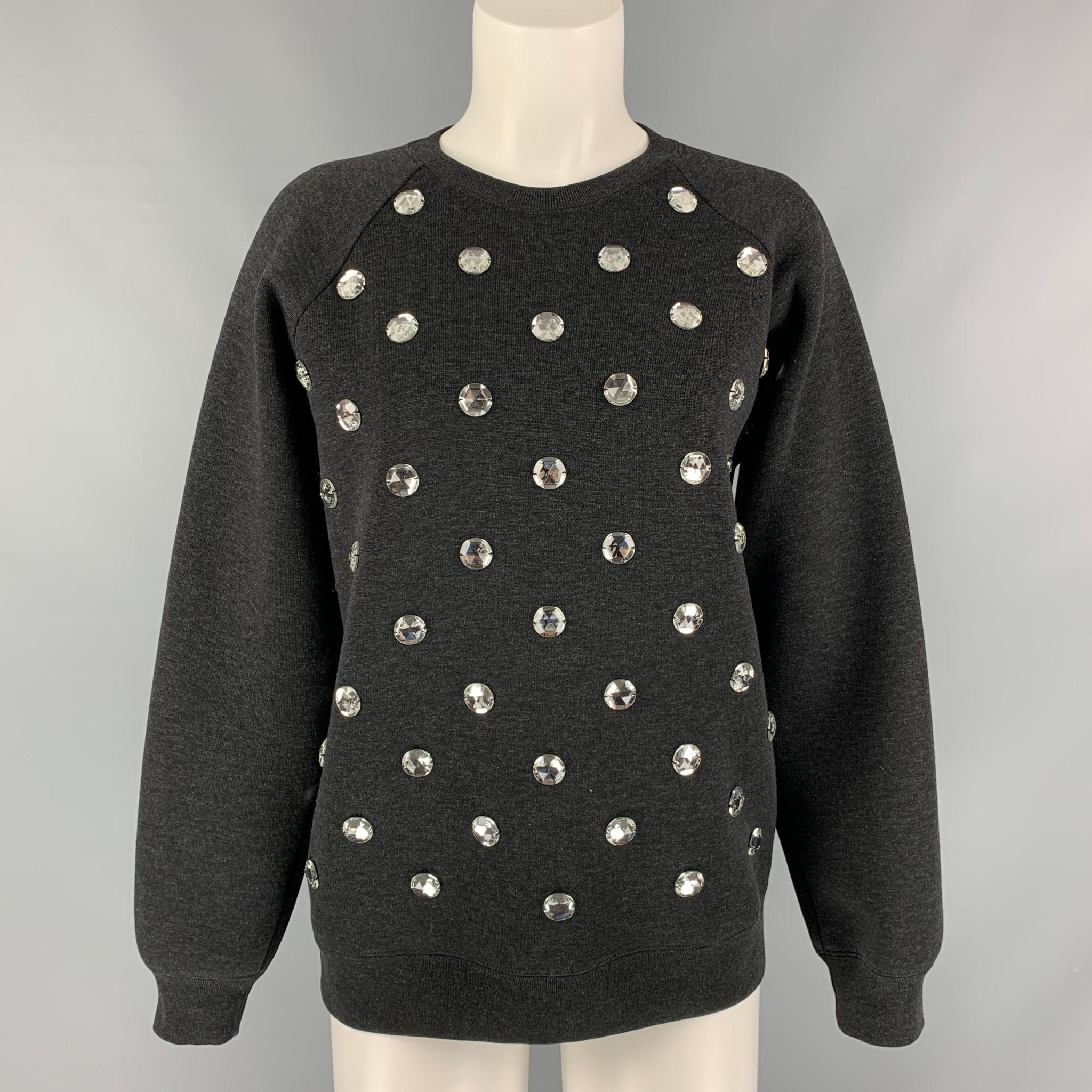 MARC JACOBS long sleeves pullover comes in a black wool blend heather jersey fabric featuring appliques at front. Made in Italy.

Excellent Pre-Owned Condition.
Marked: XS

Measurements:

Shoulder: 16.5 in.
Bust: 40 in.
Sleeve: 23.5 in.
Length: 25
