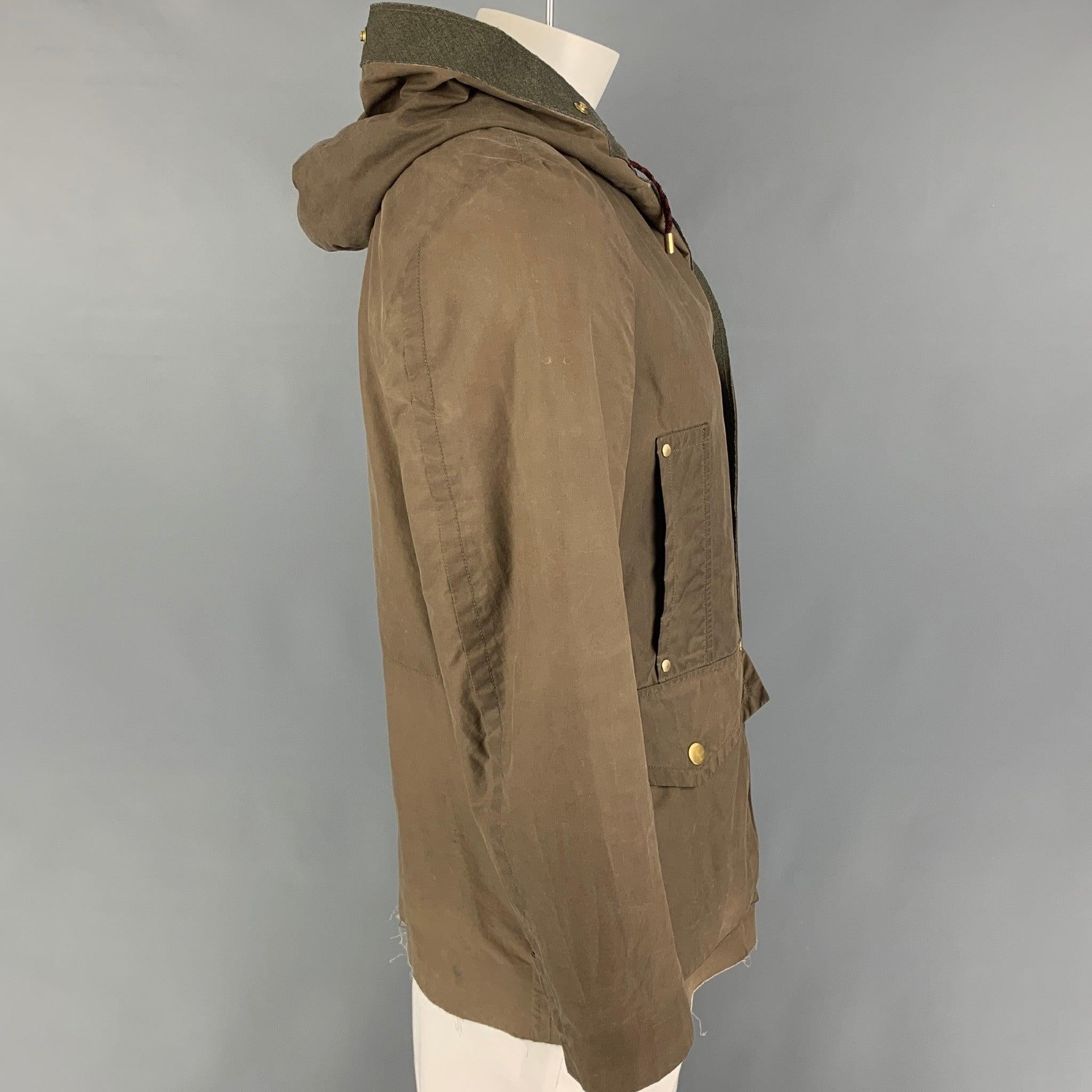 MARC JACOBS jacket comes in a olive cotton featuring a hooded style, front pockets, and a snap button closure. Made in Italy.
Very Good
Pre-Owned Condition. 

Marked:   46 

Measurements: 
 
Shoulder: 18.5 inches Chest: 44 inches Sleeve: 25 inches