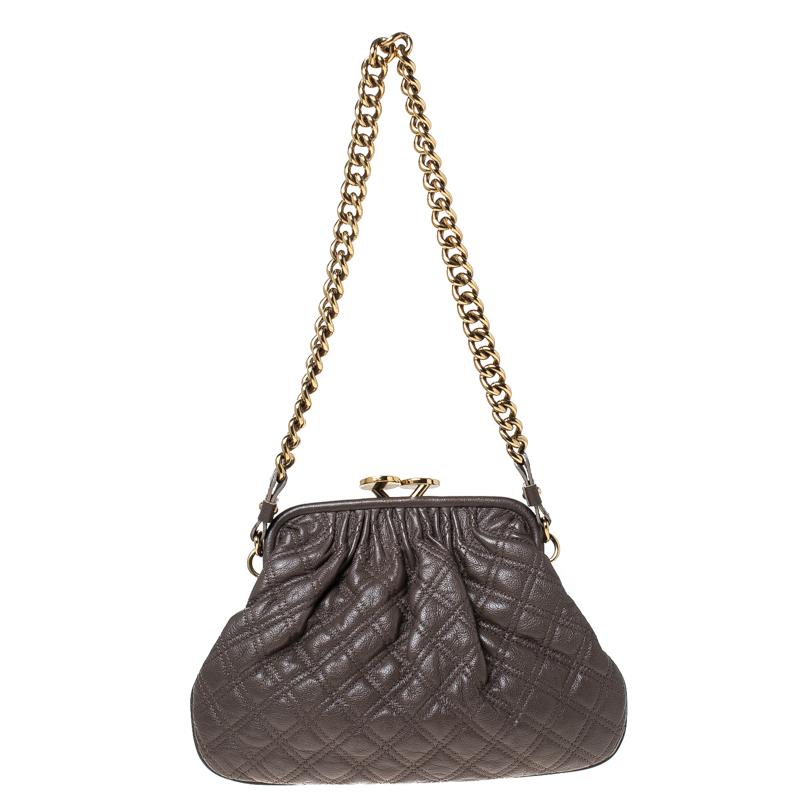 This Marc Jacobs design has a grey quilted exterior crafted from leather and enhanced with gold-tone hardware. This elegant Little Stam bag features a kiss-lock top closure that opens to a fabric interior and a chain link. Swing this beauty wherever