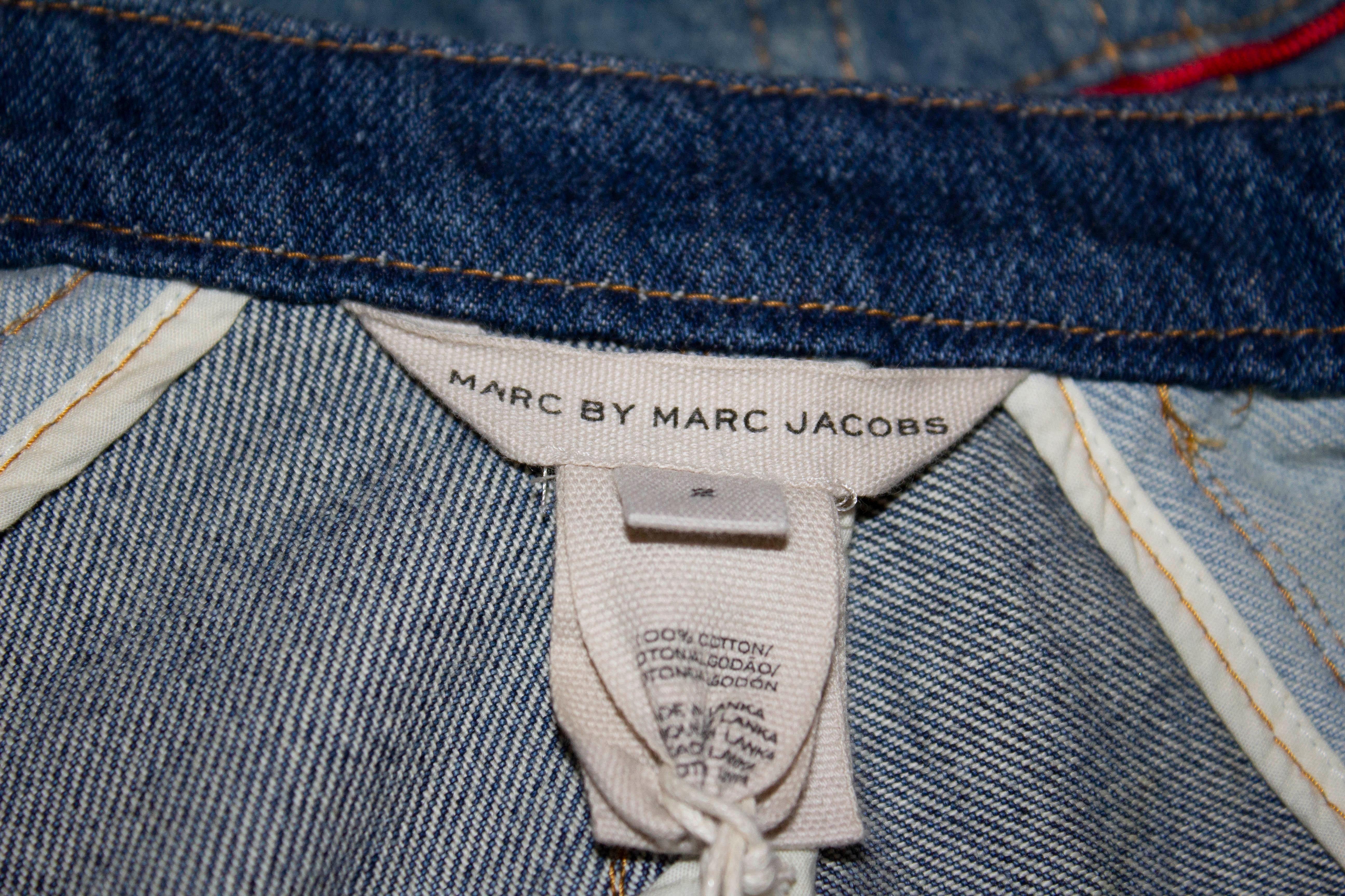 An unworn jacket by Marc by Marc Jacobs. The jacket is a size 2 , sale price $628.  The jacket has a hook and eye front  fastening, wit flap pockets at the front.  Bust up to 33'' ,length 21''.
