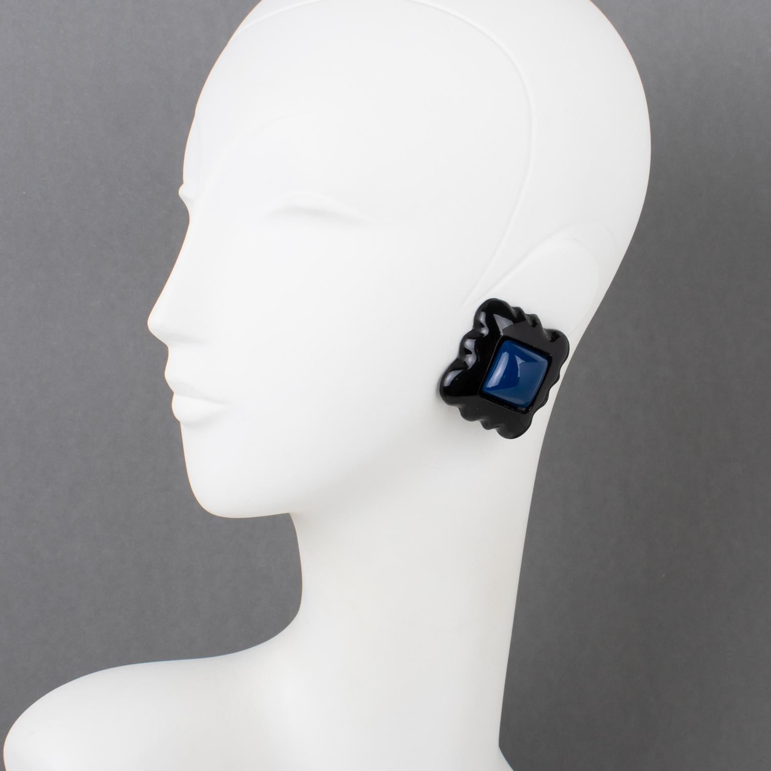 French designer Marc Labat Paris designed those charming massive resin clip-on earrings in the 1990s. The pieces feature a square scalloped shape in black color topped with a navy blue square cabochon. The original Marc Labat logo sticker is on one