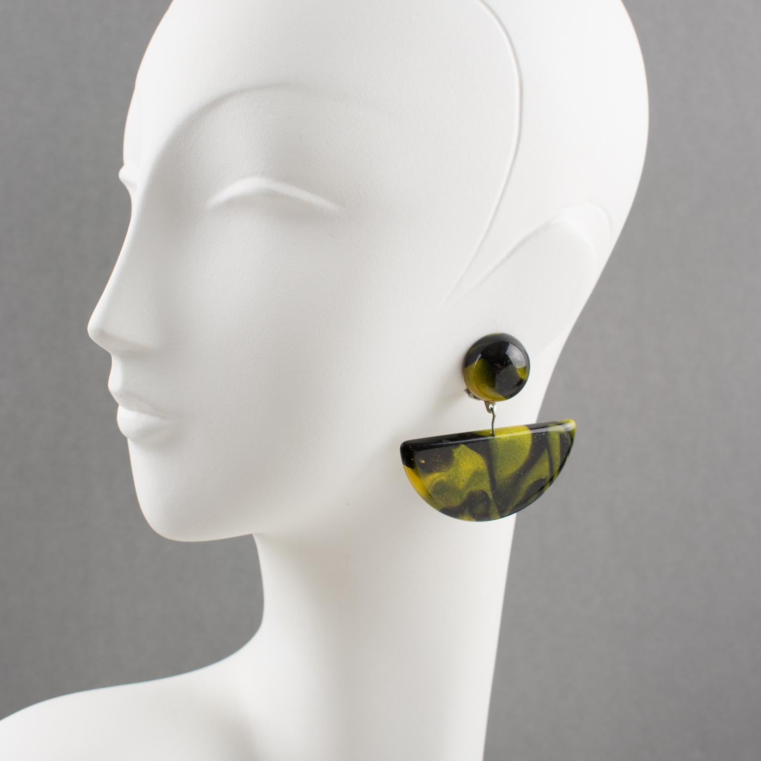 Charming oversized resin clip-on earrings by French designer Marc Labat, Paris. Dangling fan geometric shape with a pearlized pattern, yellow-green color with black cloudy swirling. Marked with the Marc Labat original sticker underside.