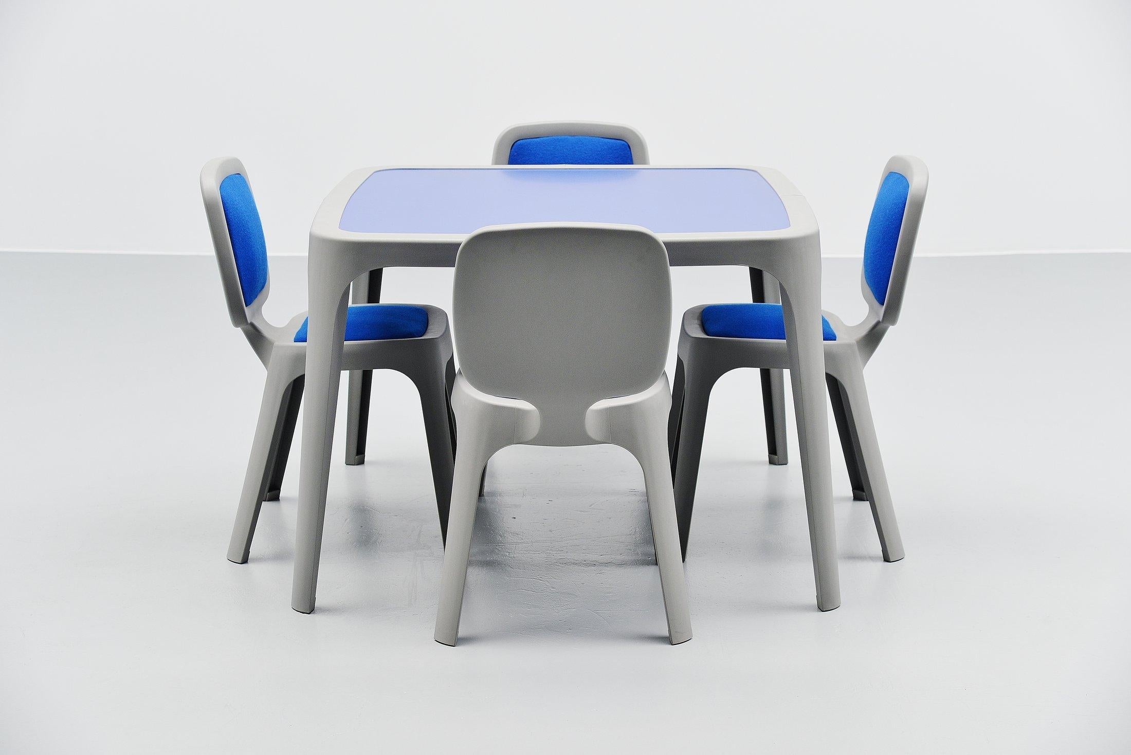 Nice contemporary 'Coast' dining set designed by Marc Newson and manufactured by Magis, Italy, 1995. The set is made of grey plastic and the top of the table is made of blue laminate. And the chairs have blue wool upholstered seats and backs. Very