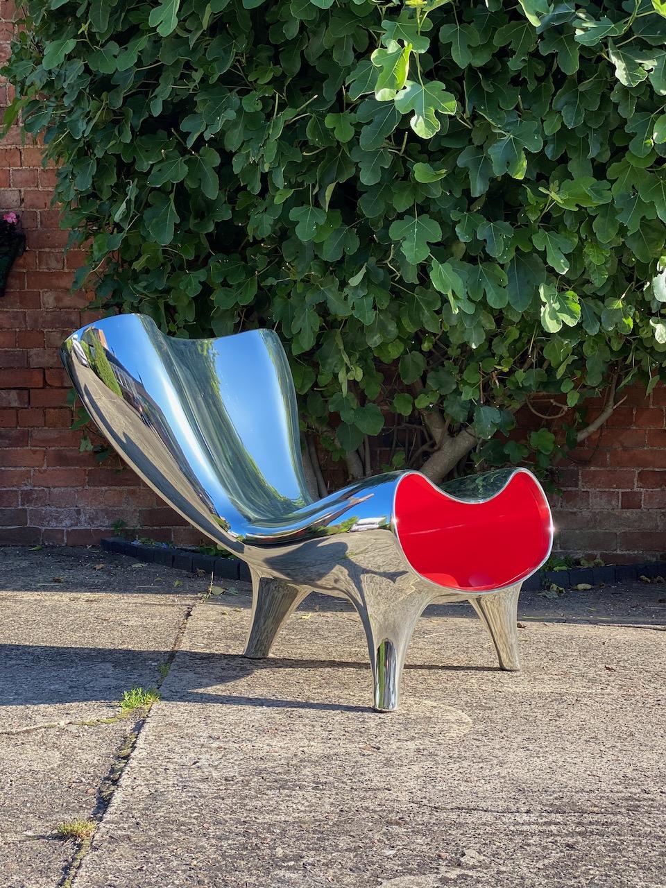 Marc Newson lockheed style chrome Orgone chair circa 1993 

Stunning Chrome finish Orgone chair after the original Lockheed design by Marc Newson circa 1993 finished in chrome ceramic paint with candy apple red guts, the Orgone chair was designed