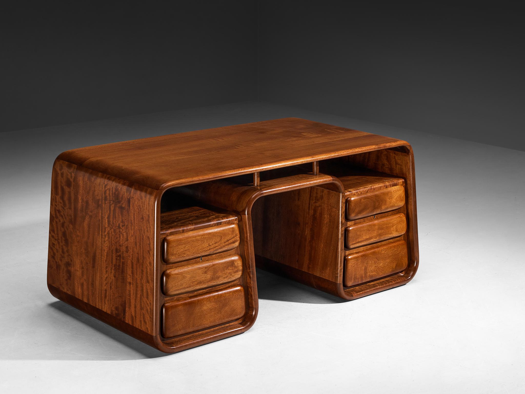 Marc van Rampelberg, freestanding writing desk, iroko, Kenya, 1980s. 

This solid Iroko freestanding desk is manufactured in Kenya and designed by the Belgian designer Marc van Rampelberg. After traveling around Africa for many years, Van Rampelberg