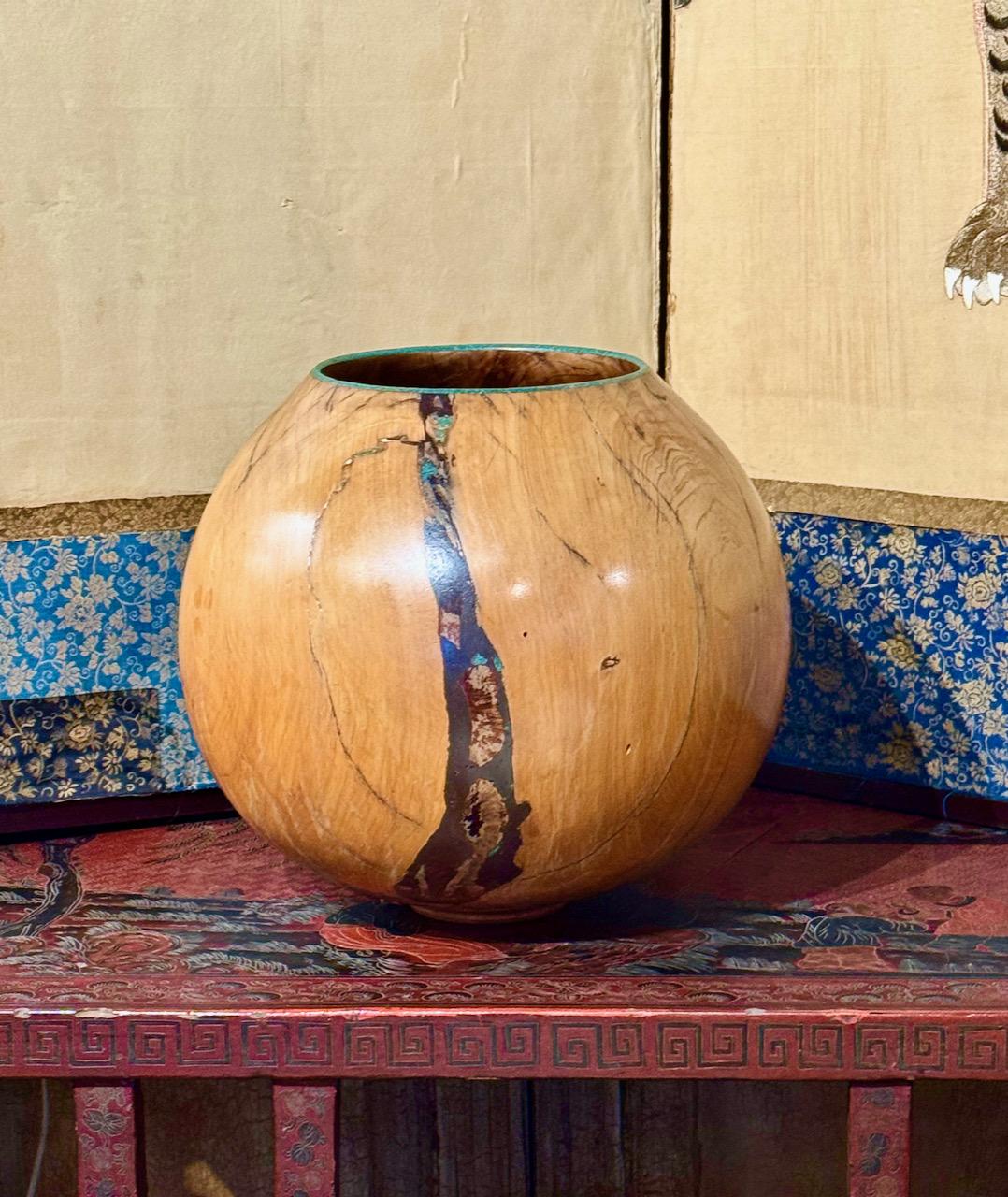This is a beautifully elaborated and finely carved Burl vessel that has been polished to a satin smoothness and inlaid with turquoise by the listed Arizona Artist, Marc Wroe. The vessel is artist signed and dated 4/1994. The beauty of the piece