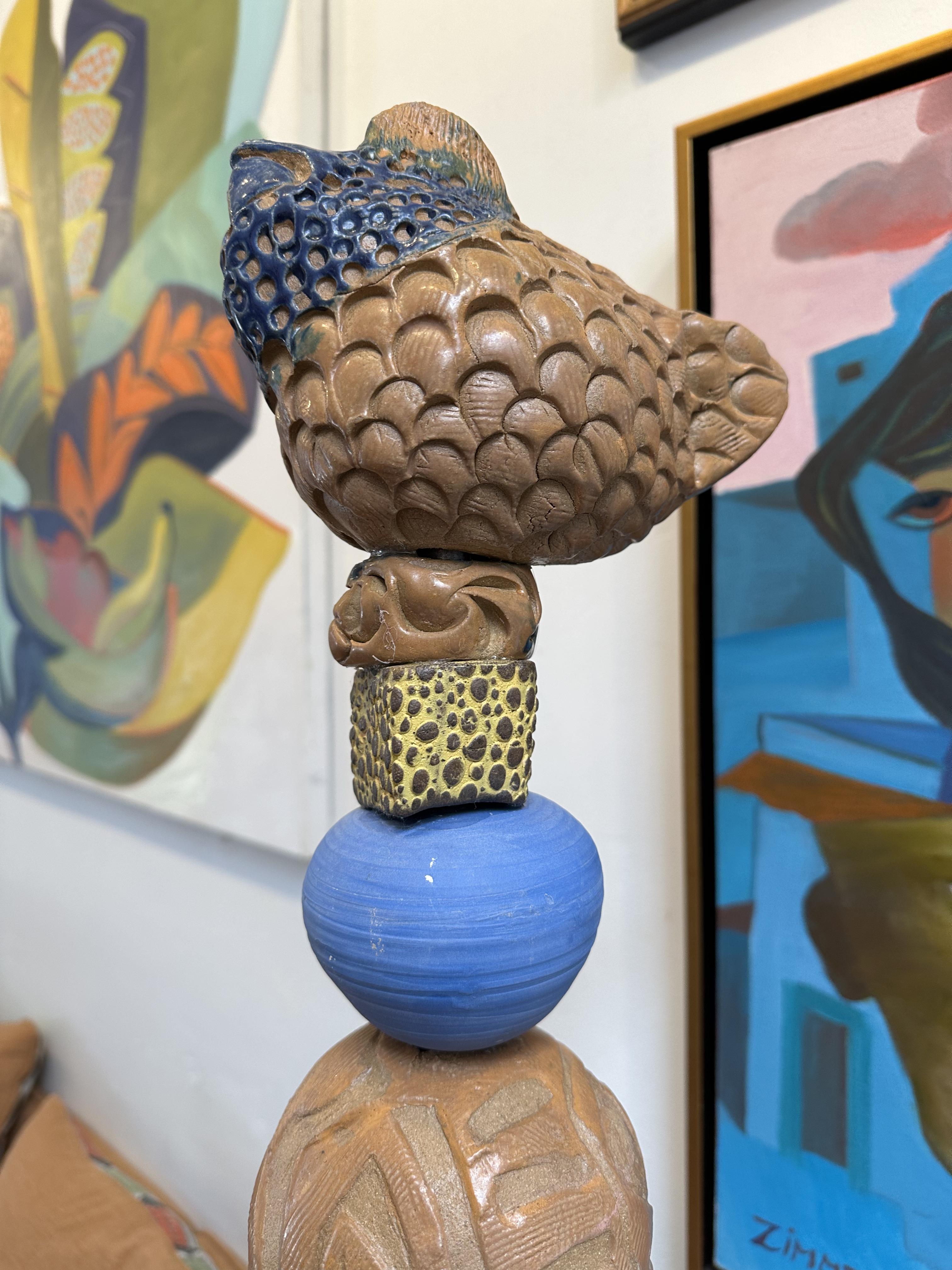 The easy to live with brown and blue color theme delights the more conservative eye. The scrafitto carving and textures create liveliness to the shapes including the playful little chicken at the top.