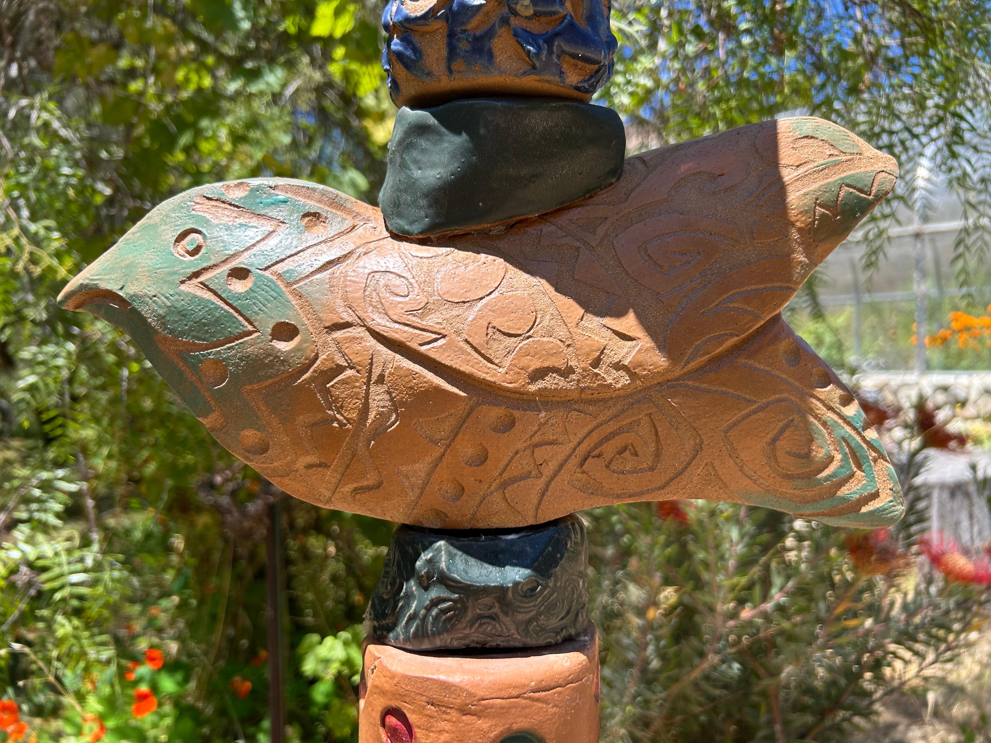 An elegant totem with a rooster top and a fishy midform. It has all the delightful texture and warm orange overall cast to make this a great garden icon