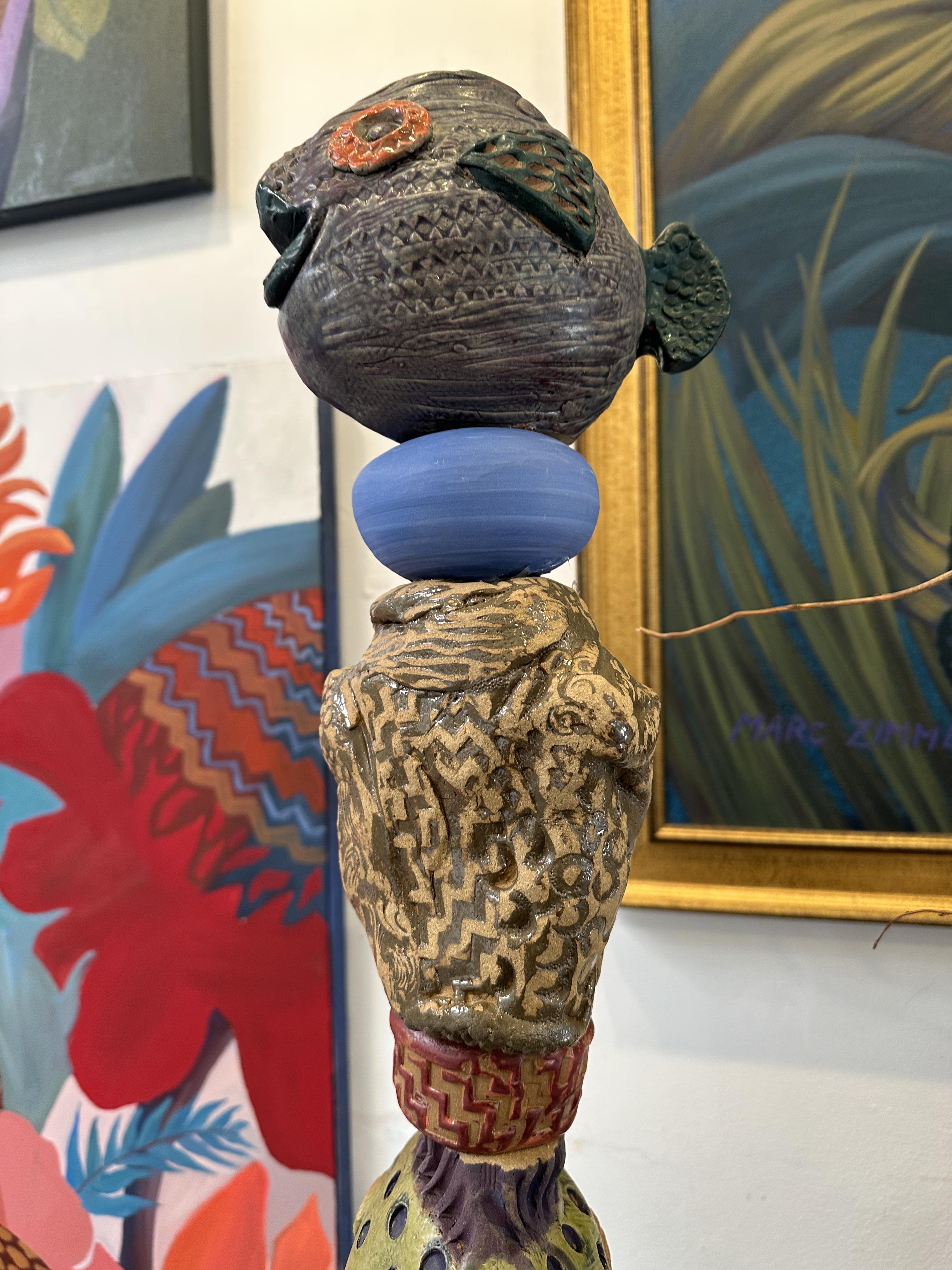 A fun play on fish ; shape color and pattern, delights and brings smiles to the viewer, weather in the garden or home.