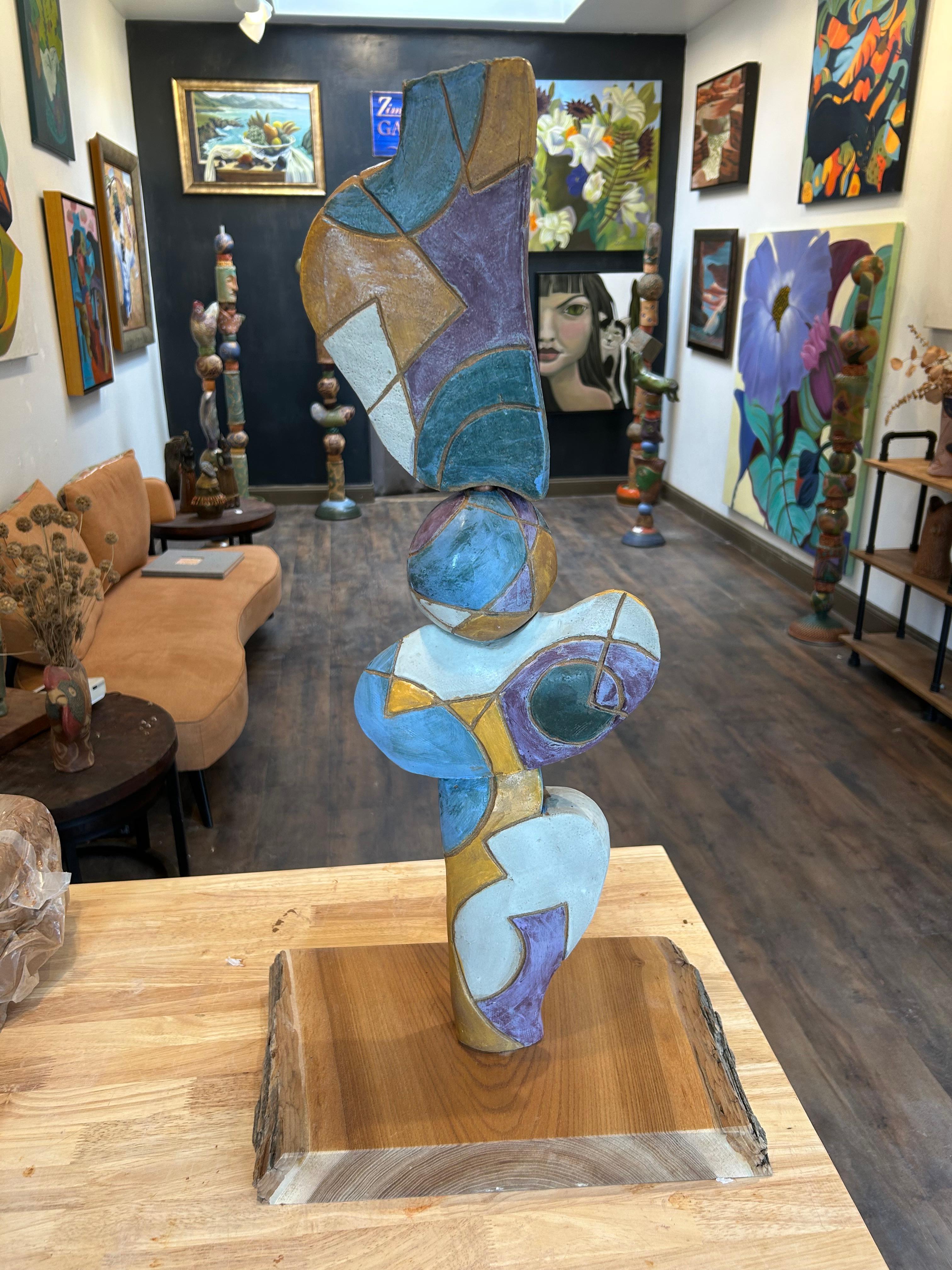 Mid fire ceramic totem designed for an interior desktop. The style is mid-century modern with line and color shapes. Featured colors are white ,blue ,pumpkin and purple. The base is 2” thick mahogony.