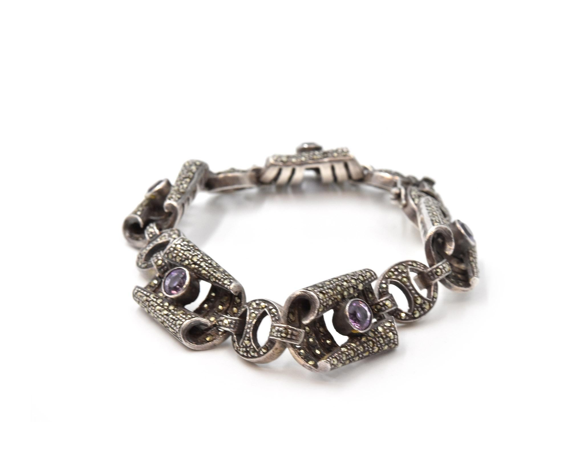 Designer: custom design
Material: sterling silver
Gemstones: marcasite & amethyst
Dimensions: bracelet will fit 7 1/2-inch wrist and 1/2-inch wide
Weight: 40.60 grams

