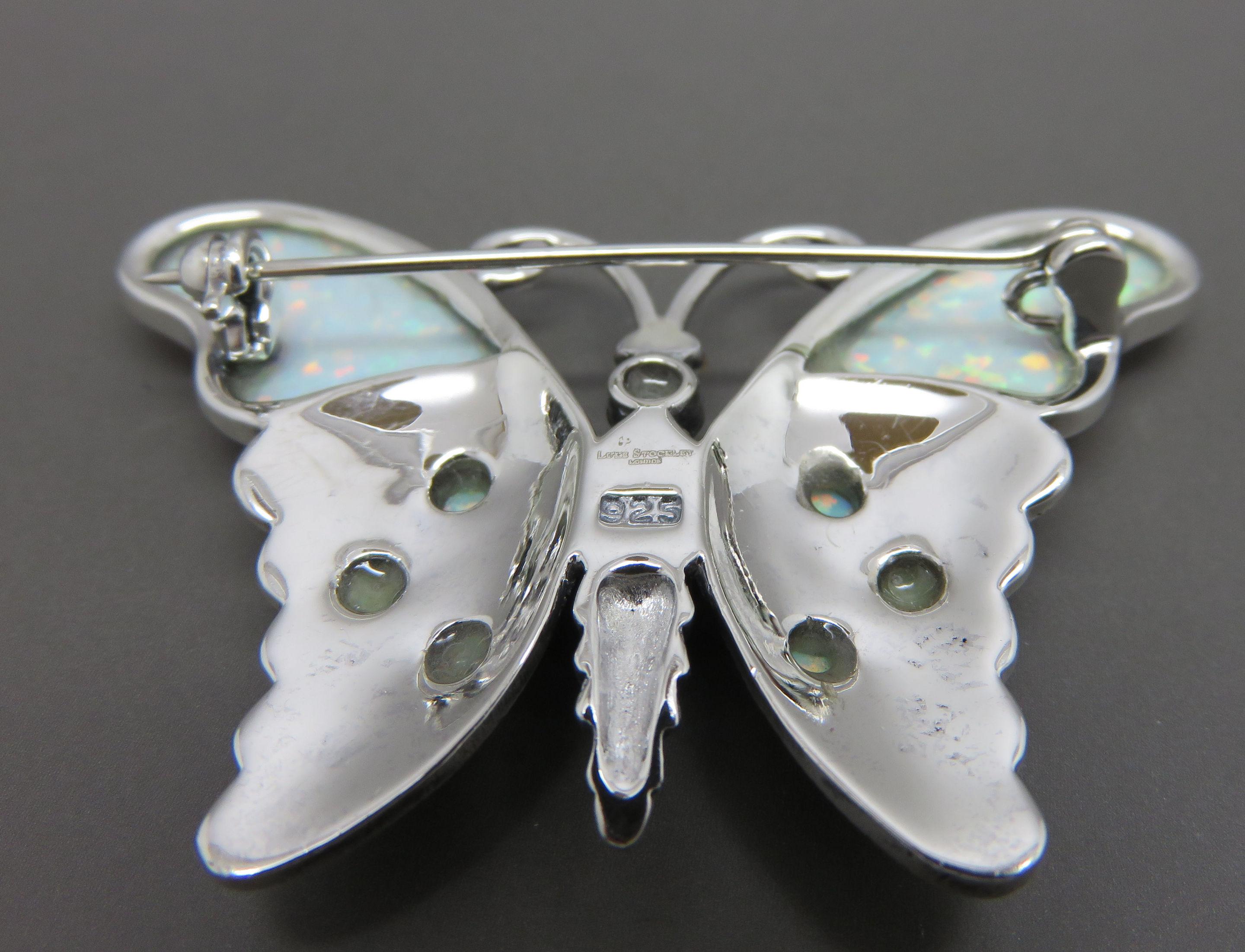 This delightful Marcasite and blue opal, silver brooch is made in the shape of a butterfly. The width at the top of the wing span is 2 inches, 5.1 cm and the length at the centre is 1.25 inches 3.2 cm. This would make a wonderful gift for a