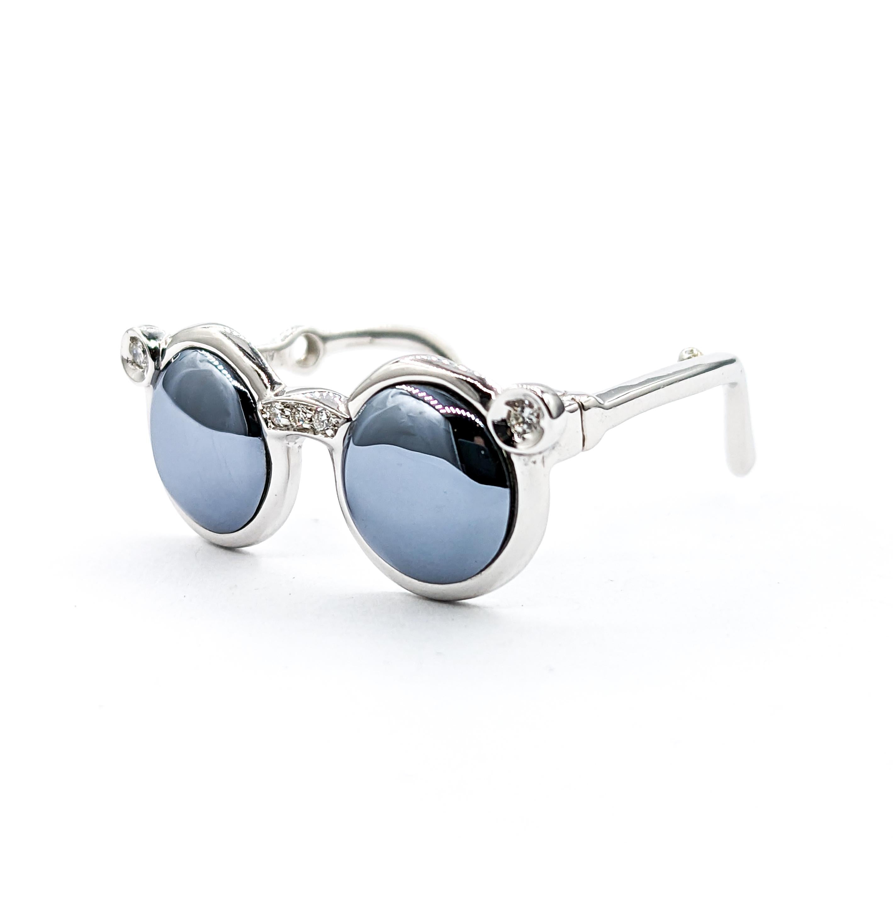 Marcasite & Diamond Sunglasses Pendant In White Gold

Introducing a stylish Pendant Sunglasses, meticulously crafted in 18kt White Gold and adorned with a .03ctw of Round Diamonds. The Sparkly Diamonds showcase SI clarity and a Near Colorless white