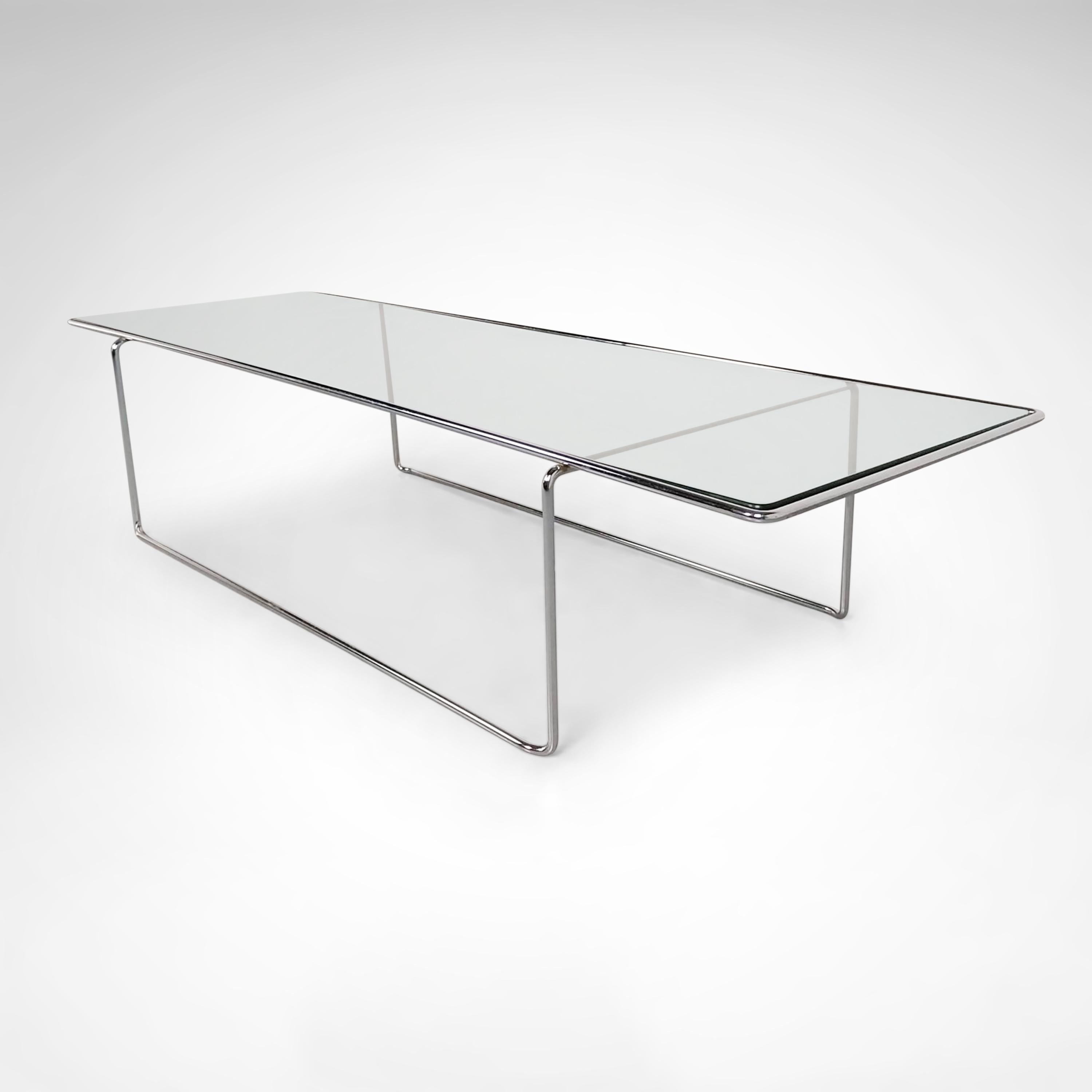 Minimalist design coffee table, inspired by Mies van der Rohe with simple abstract lines. The metal lower and upper frame are bent steel and consist of 1 part. The entire design looks very sleek due to its thin shaped frame. The glass plate lays
