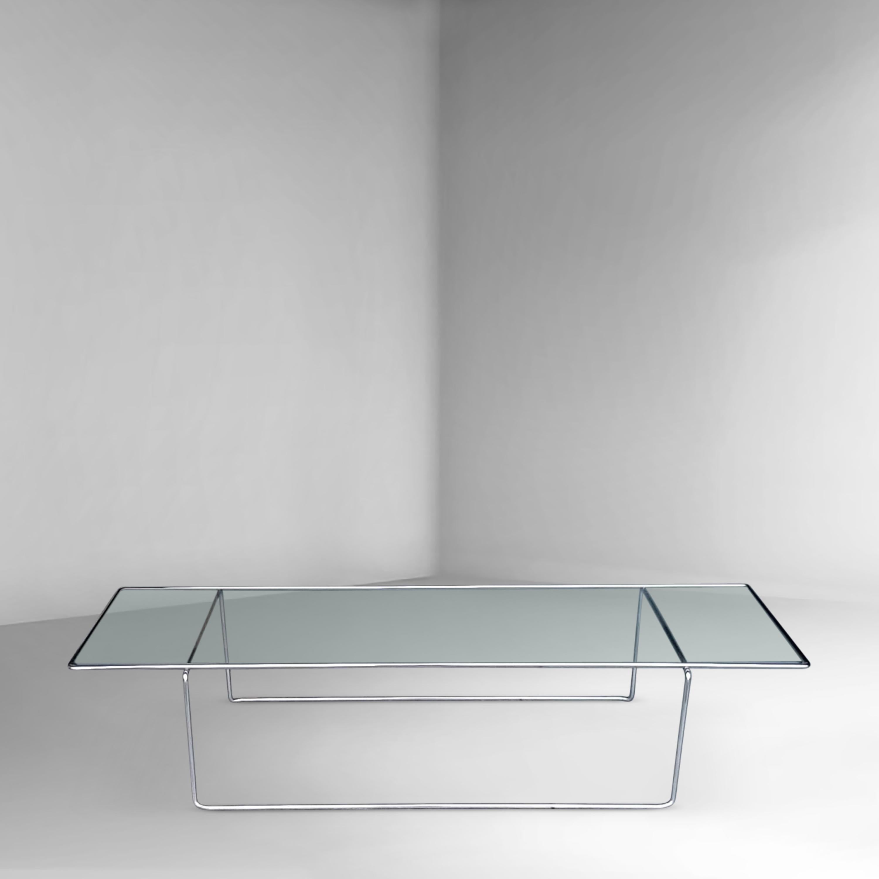 Minimalist design coffee table, inspired by Mies van der Rohe with simple abstract lines. The metal lower and upper frame are bent steel and consist of 1 part. The entire design looks very sleek due to its thin shaped frame. The glass plate lays