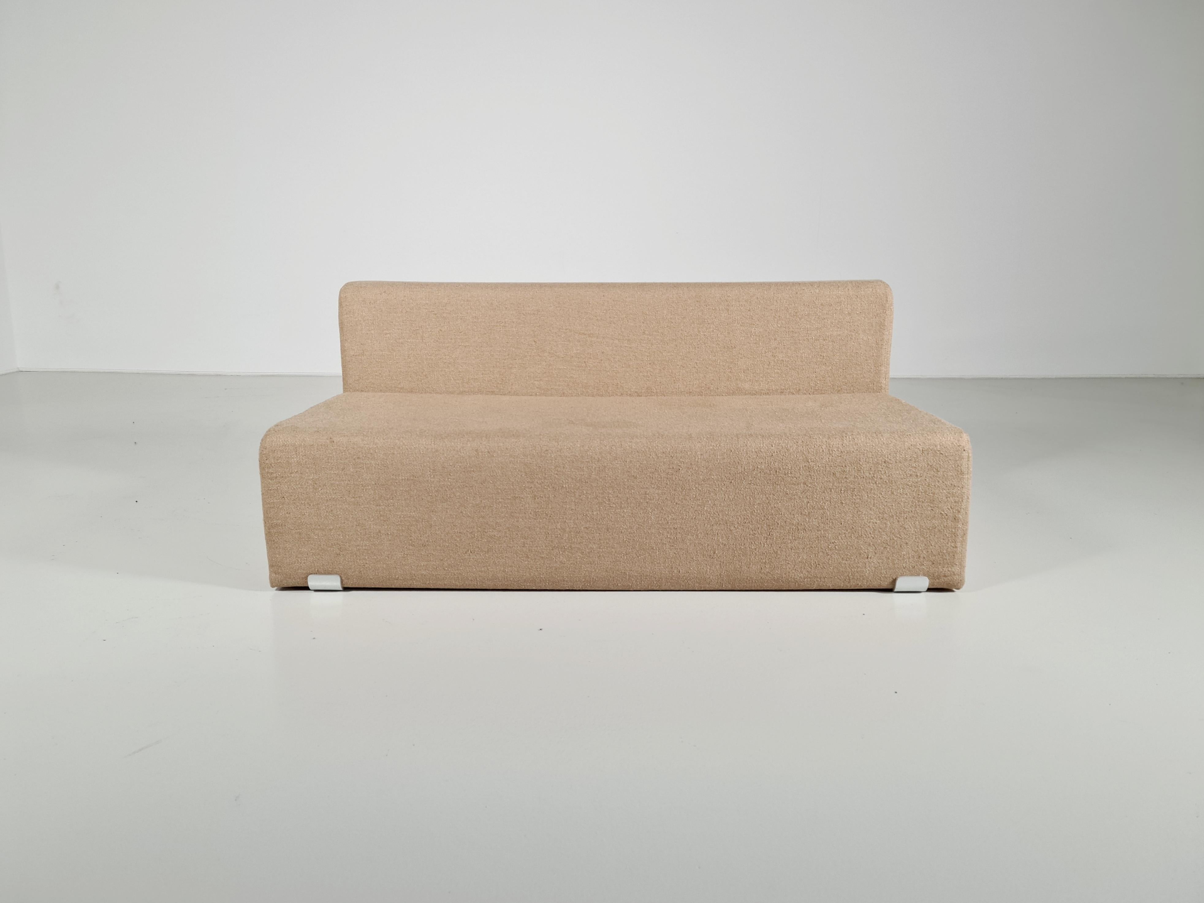 Marcel 2-seater sofa, designed by Kazuhide Takahama and manufactured by Gavina, features a shaped polyurethane structure with polished aluminum brackets. Reupholstered in a beautiful beige Tactile bouclé by Kirkby Design. The Marcel collection, a