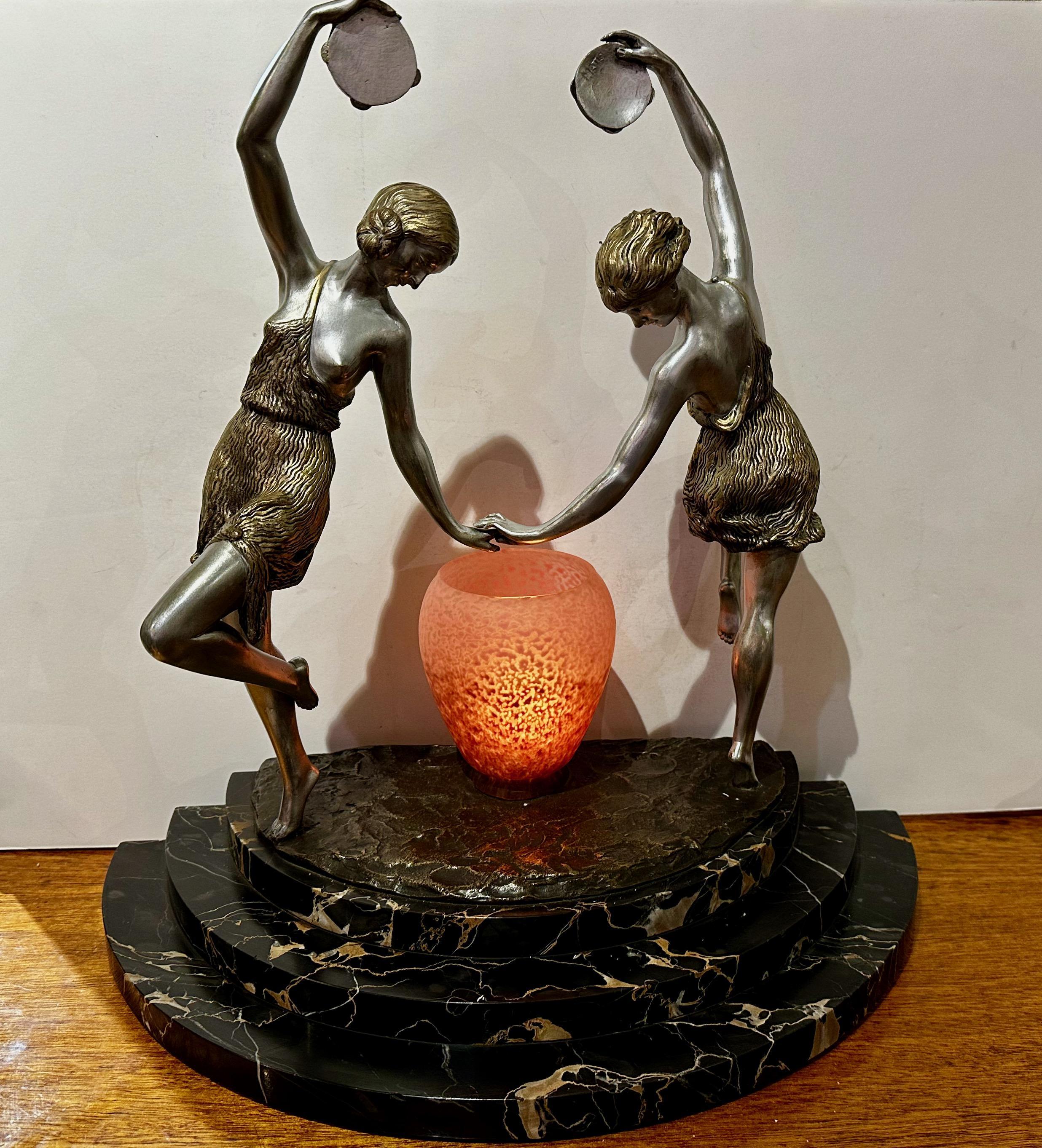1920s Art Deco Sculpture in Bronze Signed ‘Matto’ (Marcel Bouraine), Two dancing young women with tambourines and light. The bronze sculpture is on a stepped Portoro marble base. It was created in France and signed “Matto,” the pseudonym for Marcel