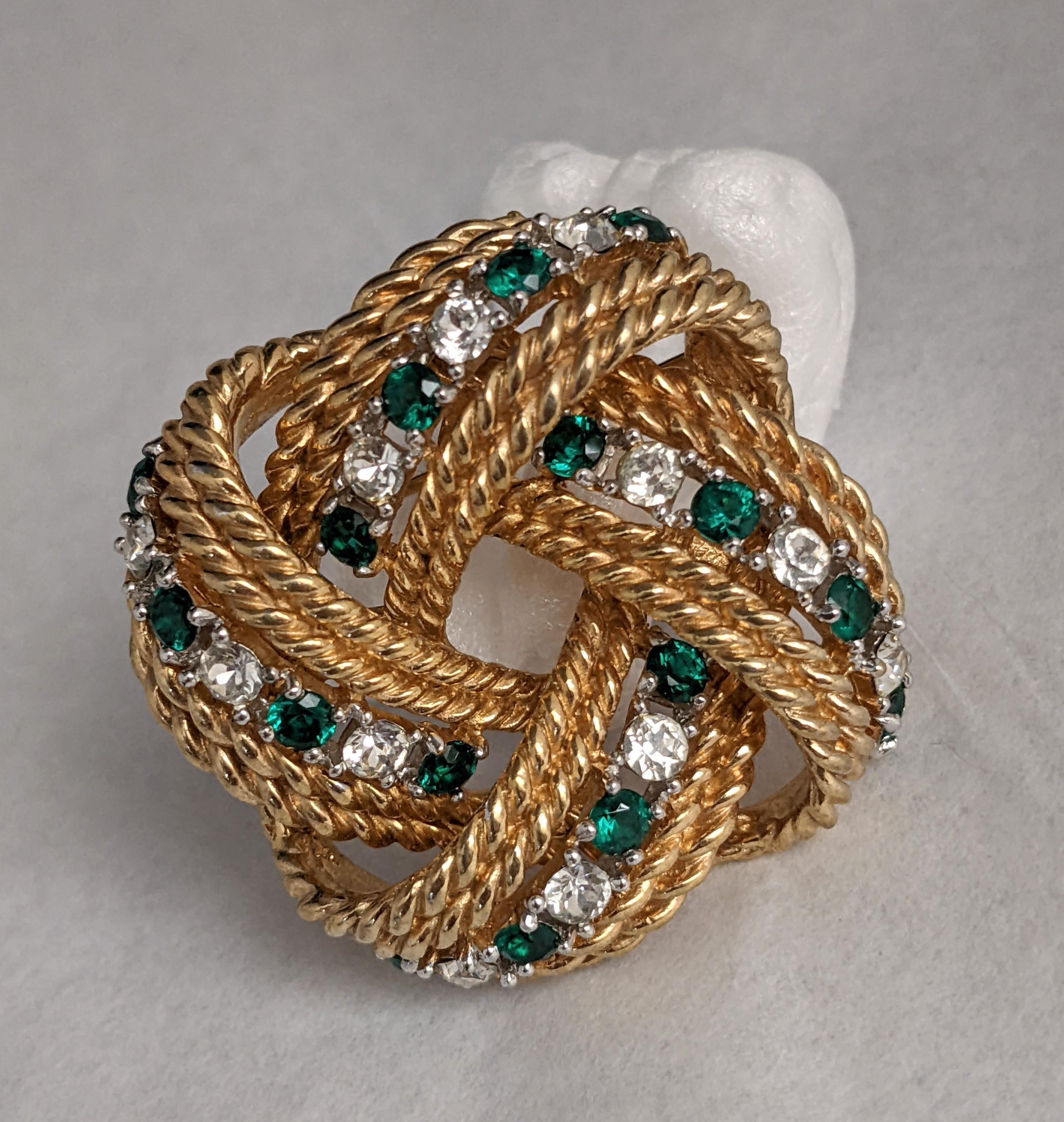 Marcel Boucher Emerald and Crystal Wreath brooch from the 1950's. Dimensional gilt wires are set with emerald and crystal pastes in this elegant brooch.
1.5